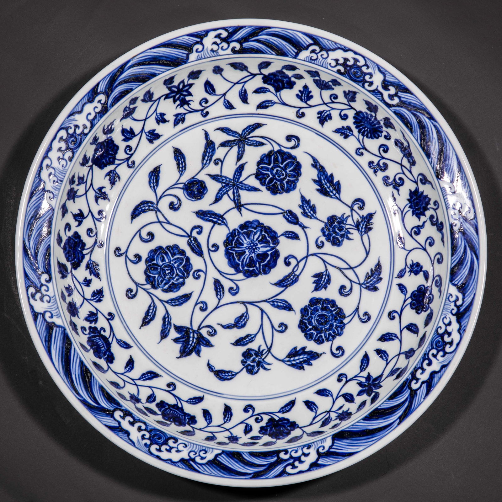 Large blue-and-white porcelain plate with wave and floral design from the Yuan Dynasty of China: Diam. 41 cm.