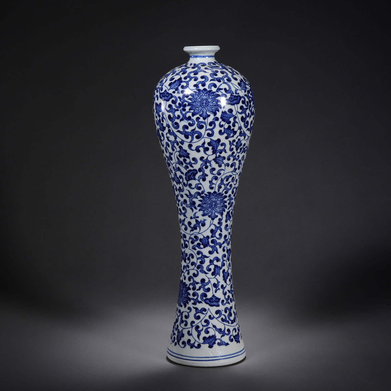 Blue and white porcelain plum vase with scrolling floral design from the Qianlong period of the Qing: H. 32 cm.
