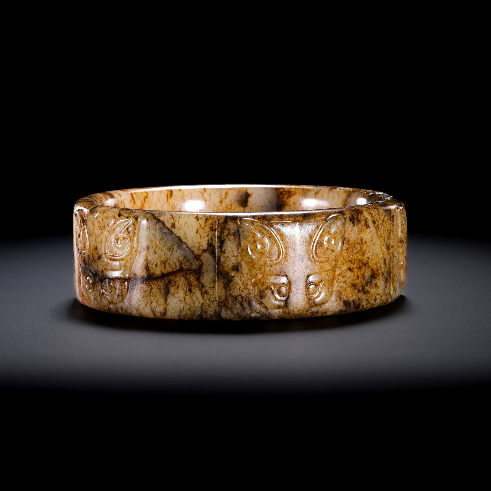 Jade Cong with Animal Mask Pattern from the Neolithic Period in China: Diam. 8 cm. W. 2.5 cm. Weight. 123 gram.