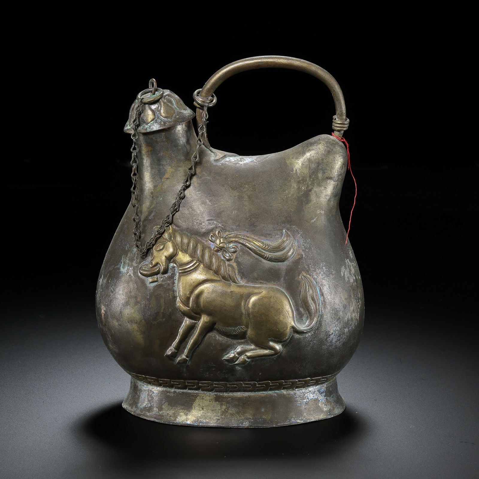A silver-gilt flat-bottomed flask with a handle from the Liao Dynasty of China: /