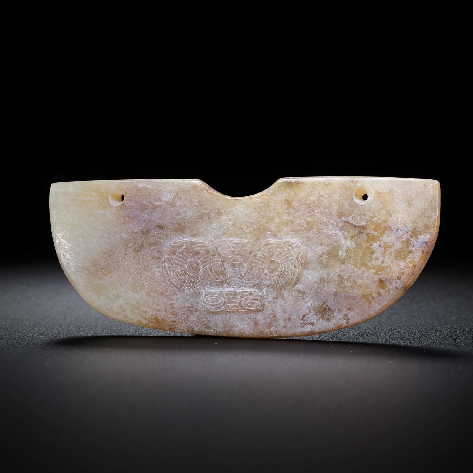 Jade huang with animal mask design from the Han Dynasty in China: H. 2.7 cm. W. 7.5 cm. Weight. 24 gram.