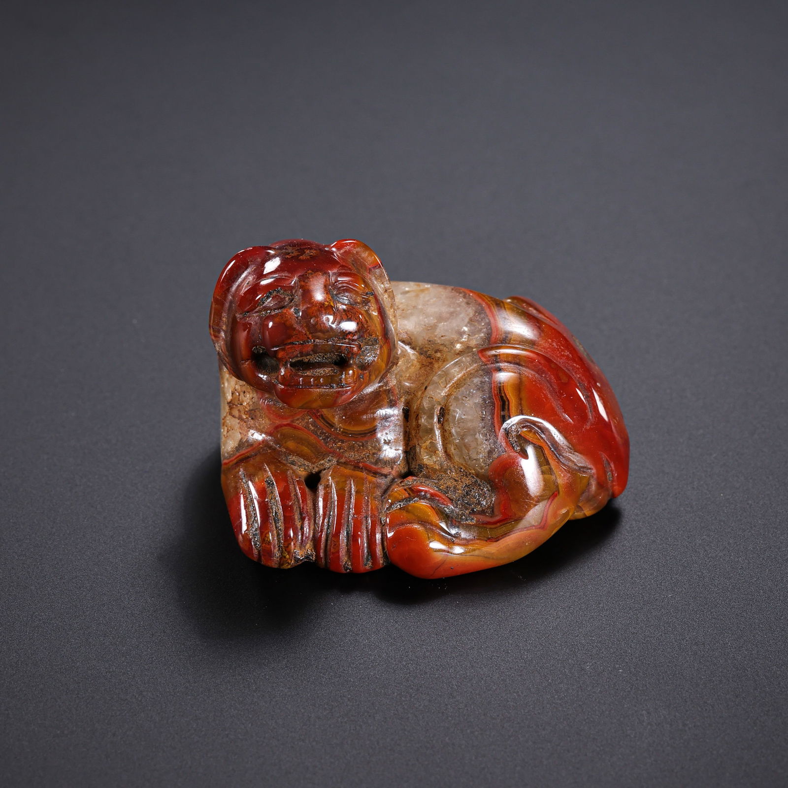 Red agate auspicious beast from the Warring States period in China: H. 2.6 cm. W. 3.7 cm. Weight. 31 gram.