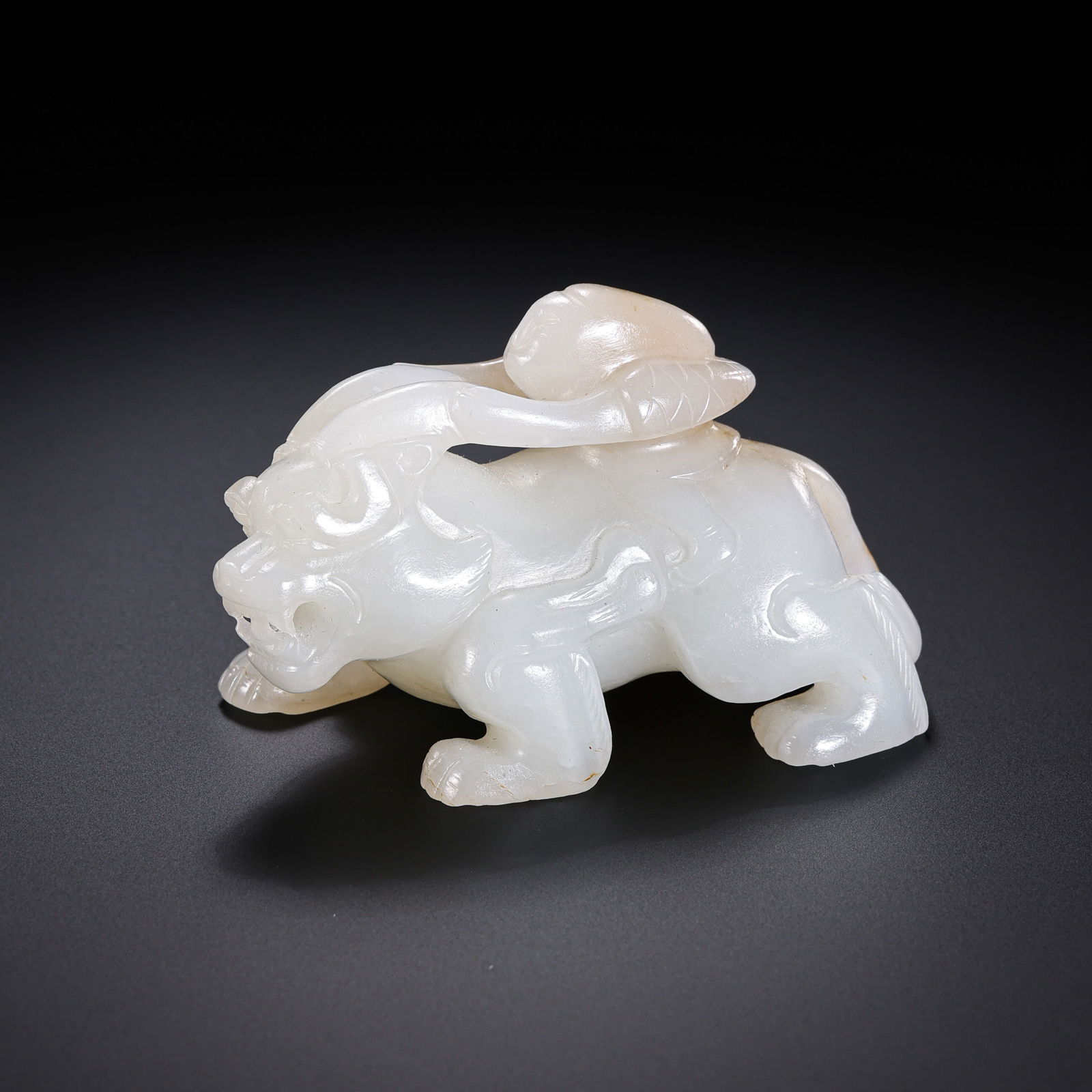 White Jade Auspicious Beast from the Han Dynasty in China: H. 4 cm. W. 6.5 cm. Weight. 88 gram.