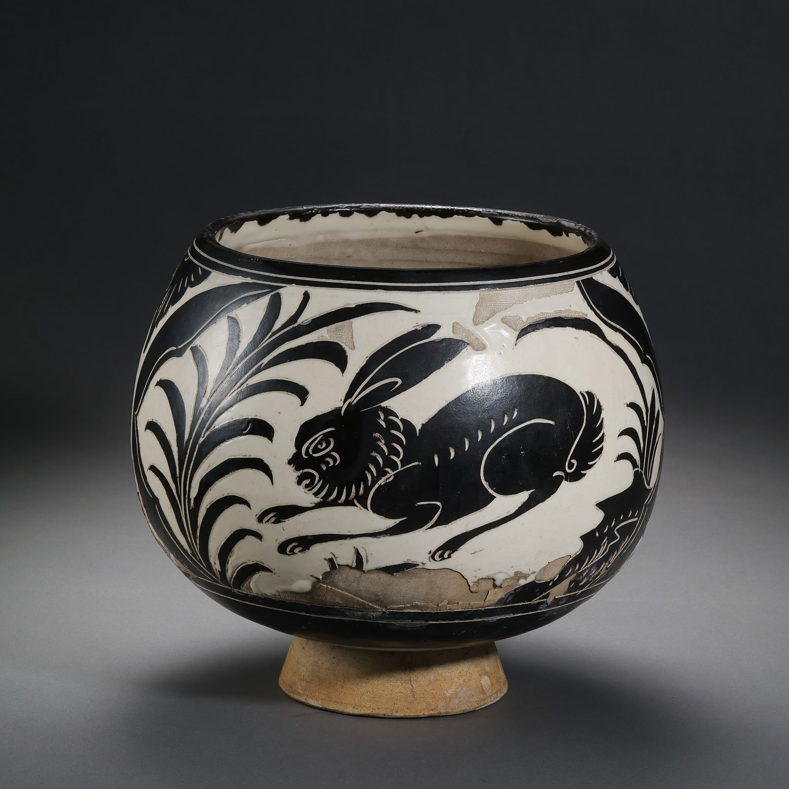 A white-glazed jar with black rabbit design from the Cizhou kiln of the Northern Song Dynasty in: H. 22 cm. W. 24 cm.