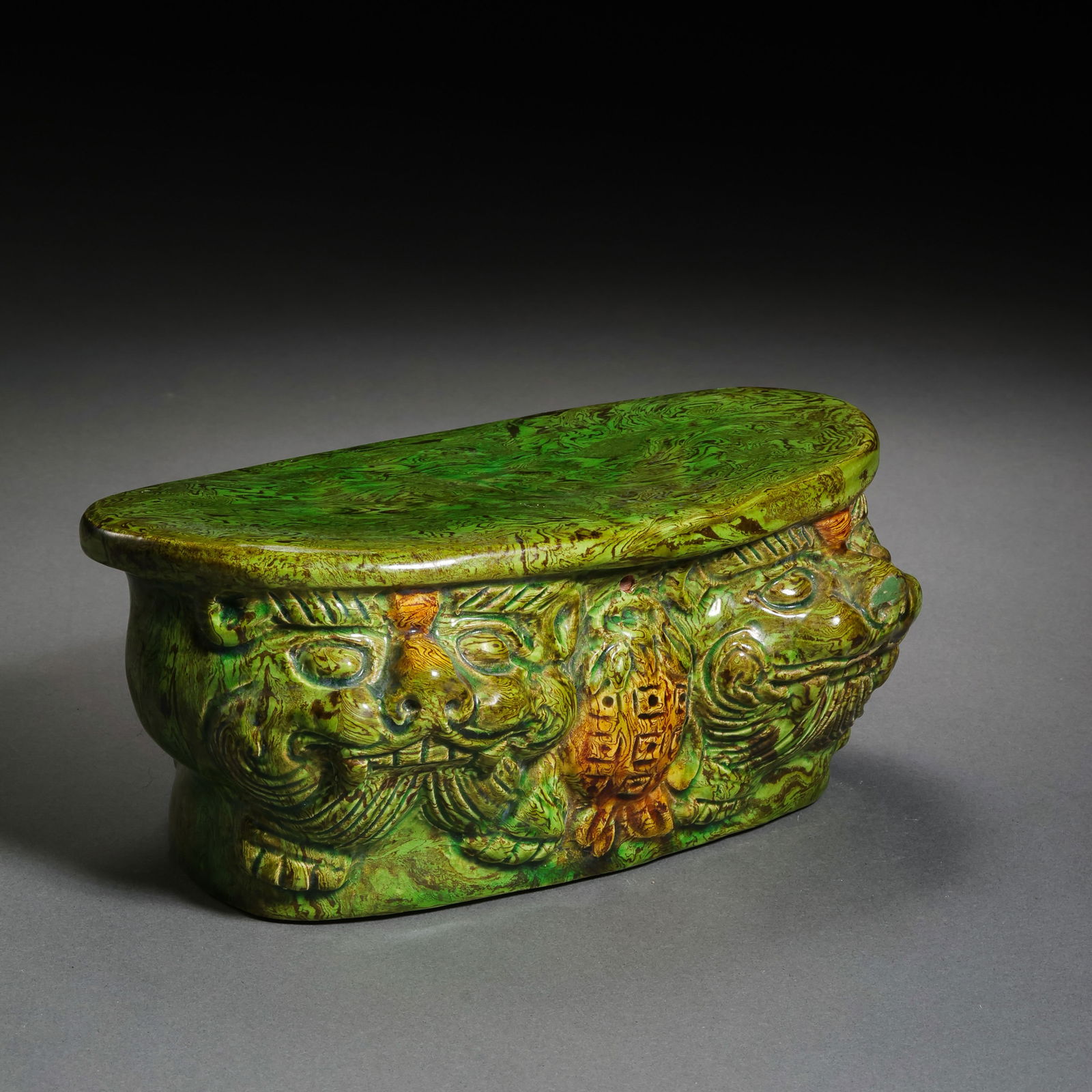 Chinese Tang Dynasty Green-Glazed Marbled Pillow with Auspicious Beast Design: H. 6.5 cm. W. 14.7 cm.