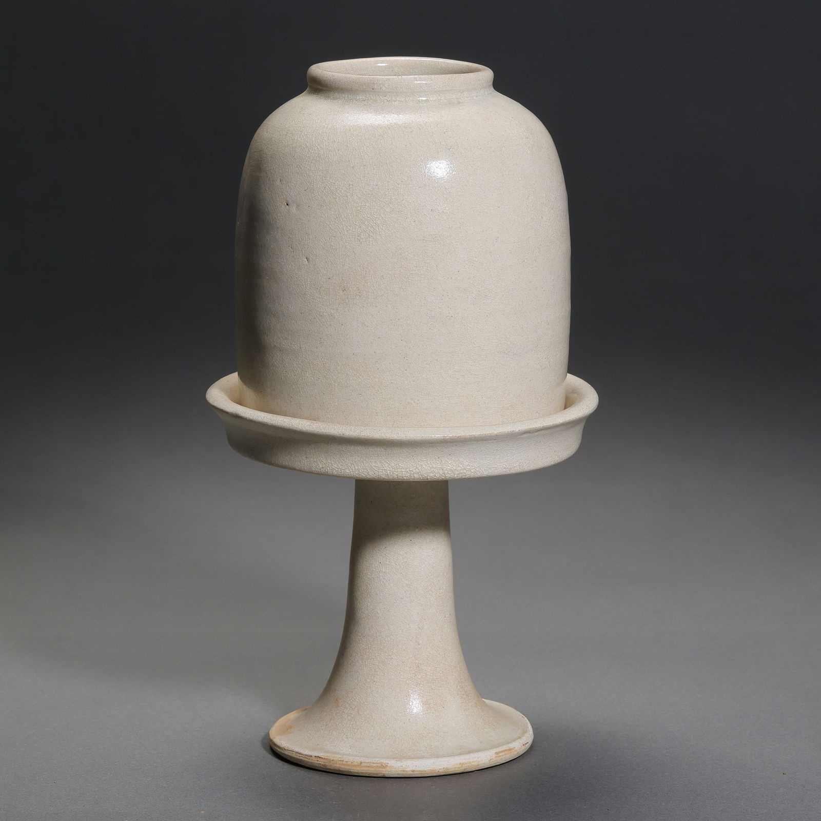 Chinese Sui Dynasty white porcelain high-footed water vessel: H. 17.5 cm. Diam. 10.5 cm.