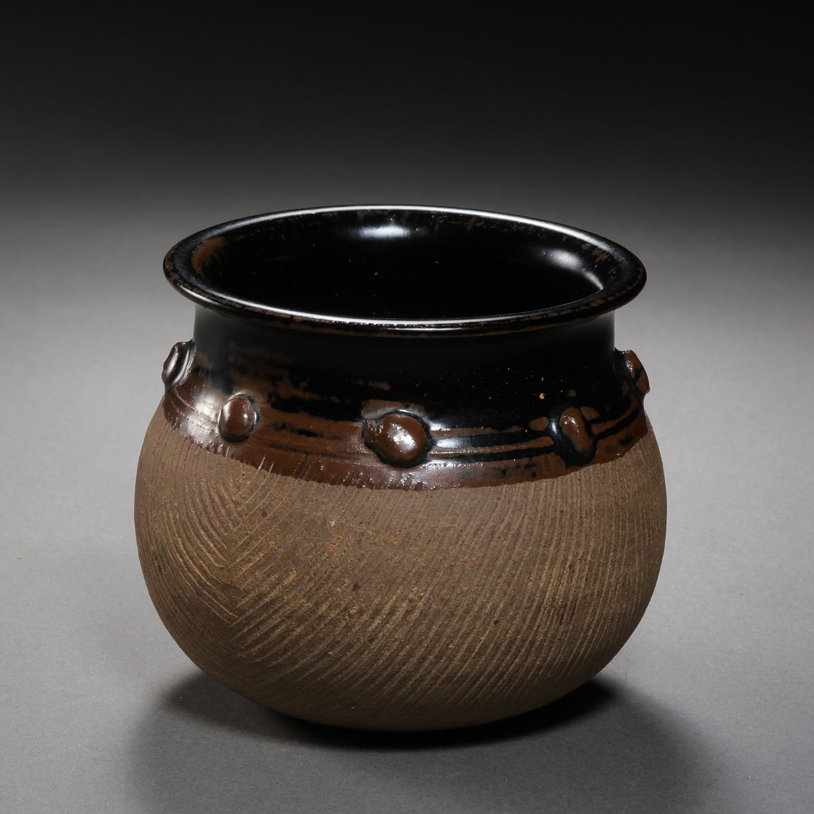Northern Song Dynasty Cizhou Kiln Black Glazed Unglazed Jar with Drum Nail Design: H. 8.5 cm. Diam. 12 cm.