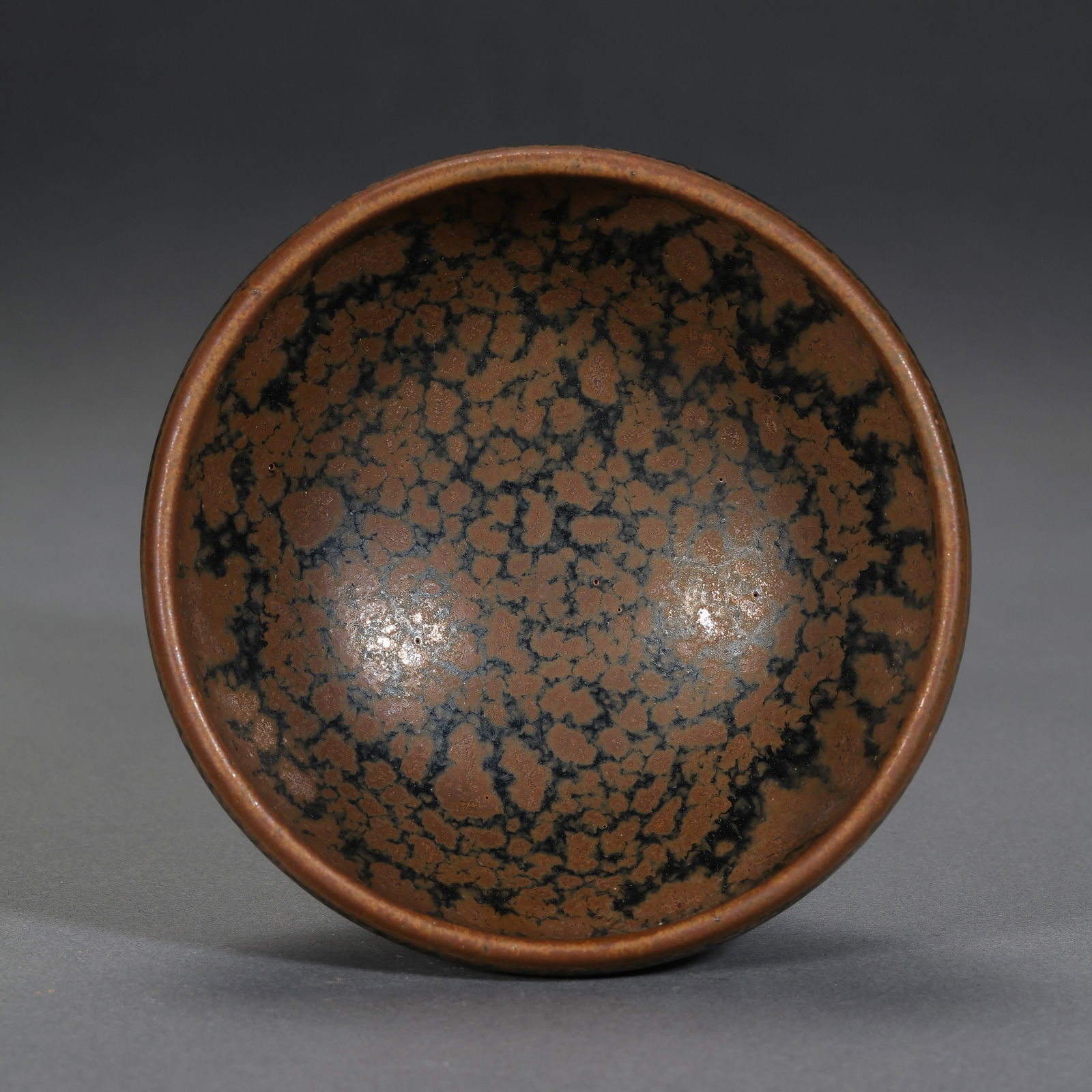 Small iron-rust-spotted cup from Cizhou ware, Northern Song Dynasty, China: H. 4.5 cm. Diam. 9 cm.