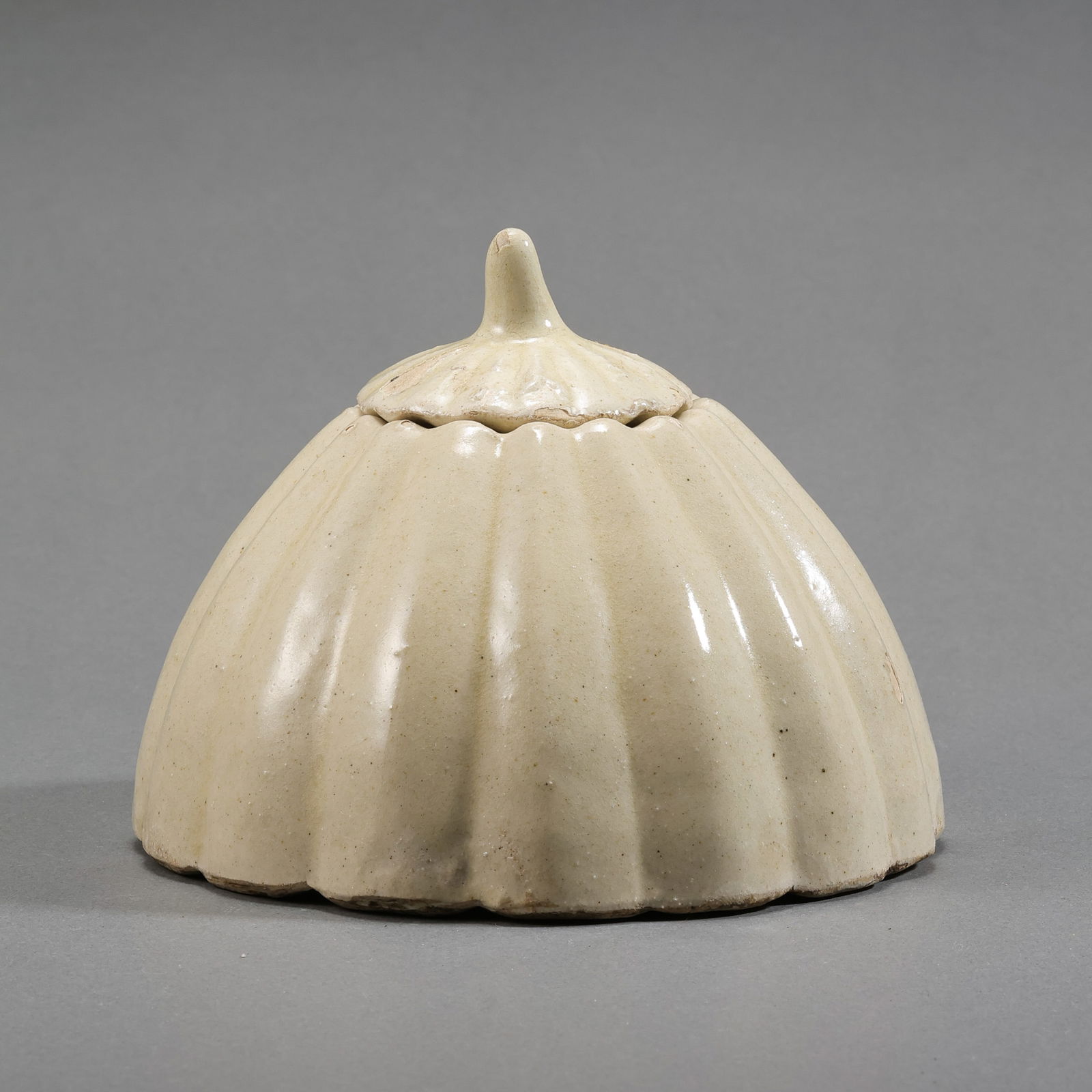 Northern Song Dynasty Cizhou Kiln White Glazed Pumpkin-Shaped Jar: H. 10 cm. W. 11 cm.