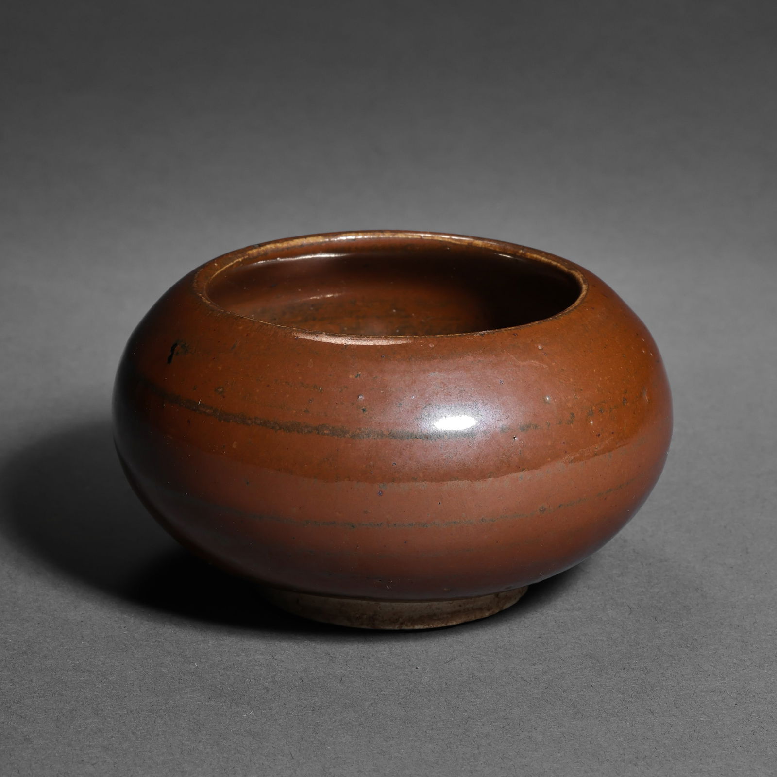Red-glazed water dropper from Cizhou ware, Northern Song Dynasty, China: H. 5 cm.