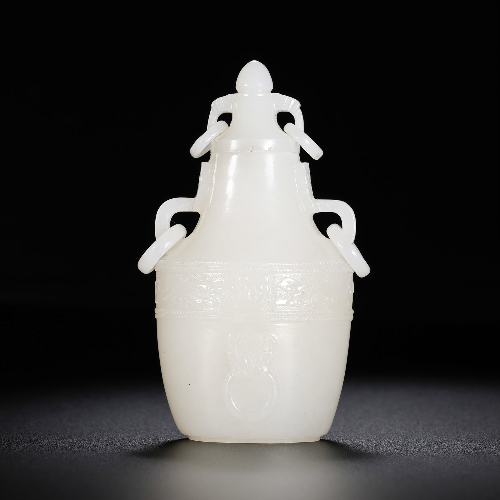 Chinese Qing Dynasty Hetian white jade double-ring-eared covered bottle: H. 9.6 cm. W. 5.2 cm. Weight. 136 gram.