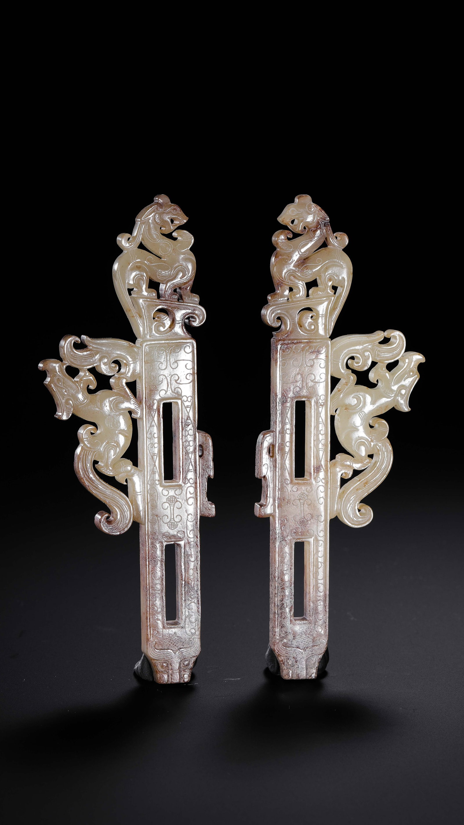 A pair of Chinese Han Dynasty jade artifacts with dragon motifs: H. 12.3 cm. W. 4.1 cm. Weight. 70 gram.
