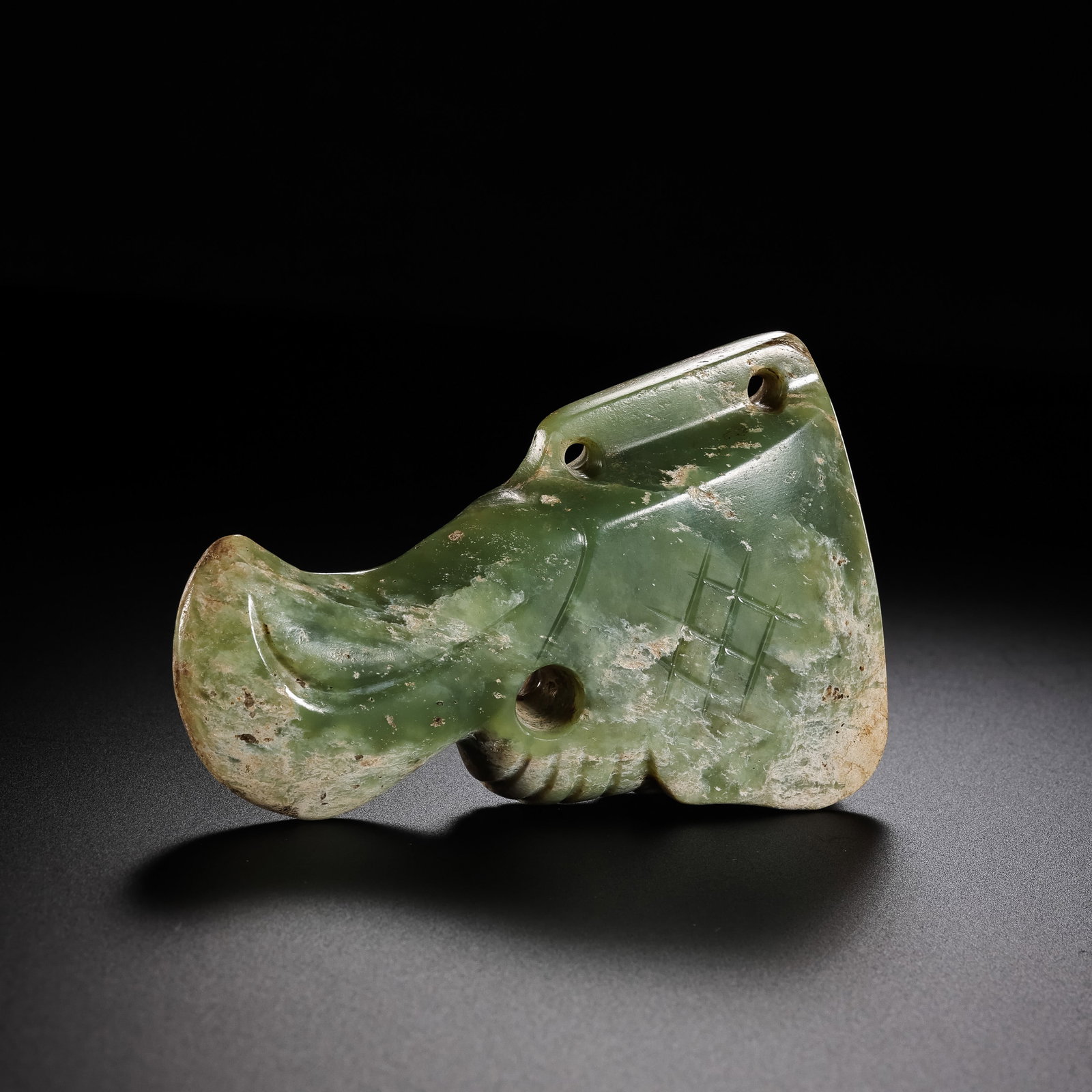 Jade owl head from the Hongshan Culture of the Hongshan period in China: H. 5.5 cm. L. 8.5 cm. Weight. 116 gram.
