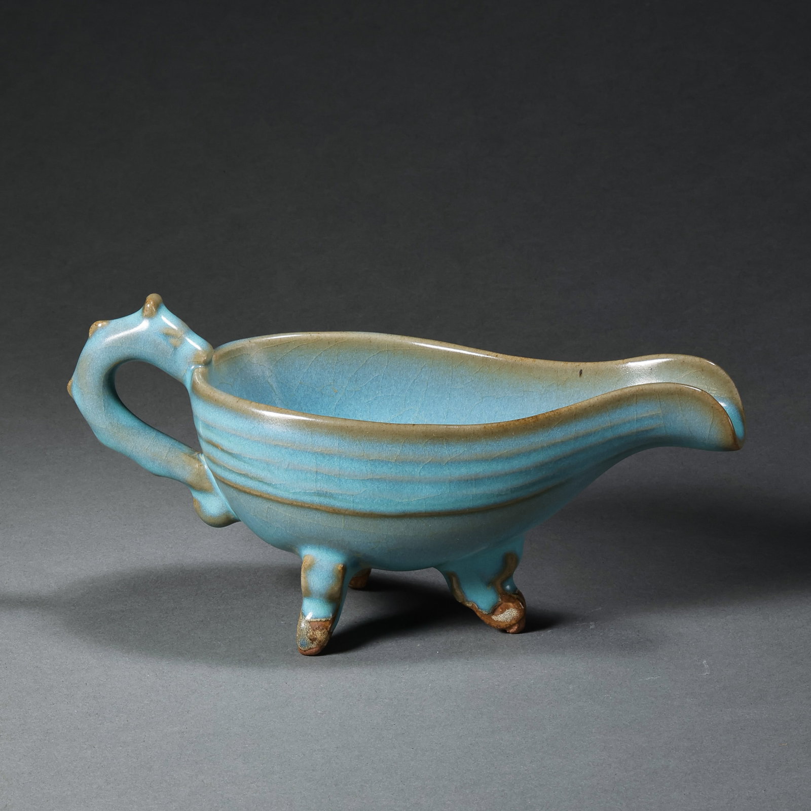 A Northern Song Dynasty Jun ware cup with sky-blue glaze and red trim on three legs.: H. 8 cm. L. 16.7 cm.