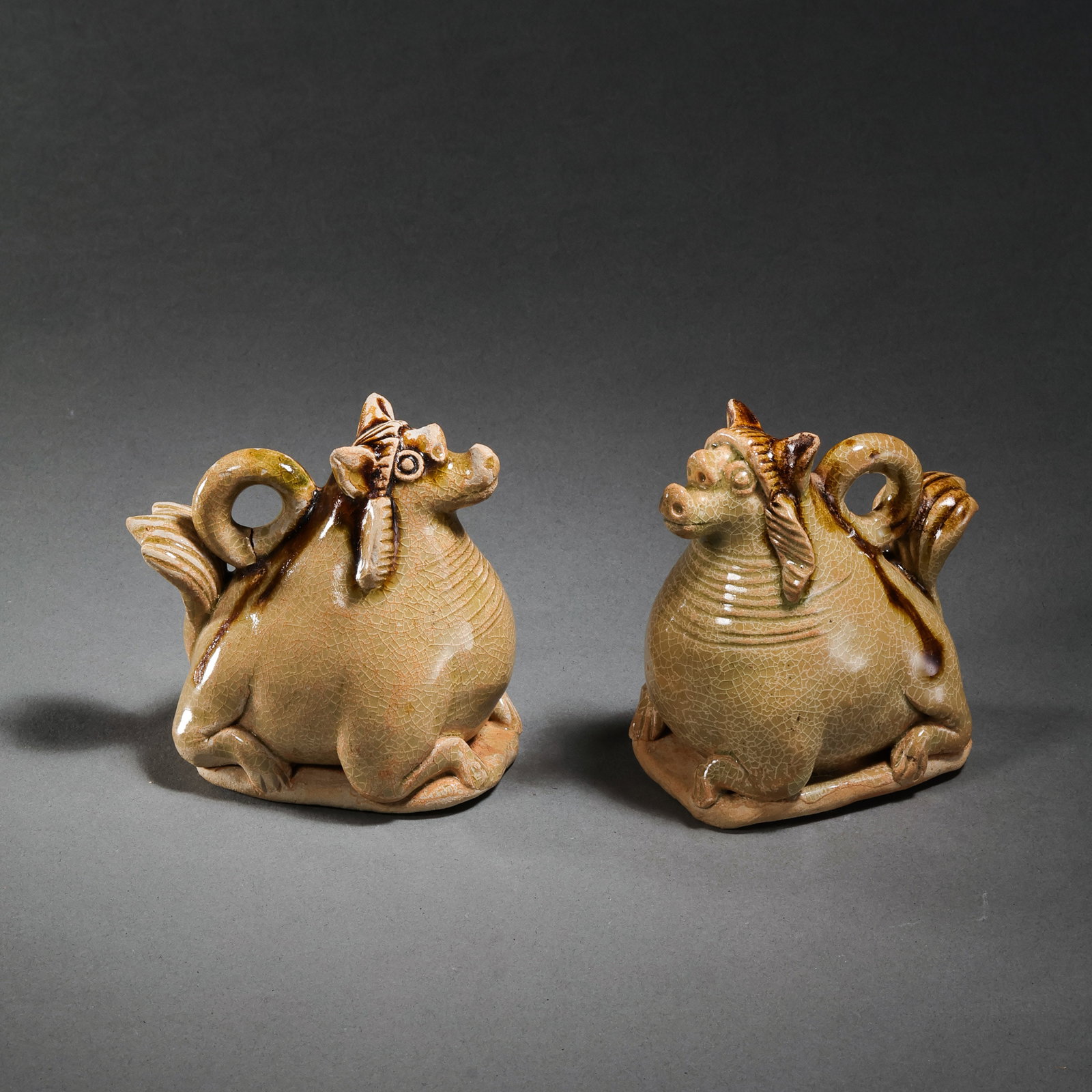 A pair of painted auspicious beasts from the Changsha kiln of the Tang Dynasty in China: H. 7 cm. W. 6.8 cm.