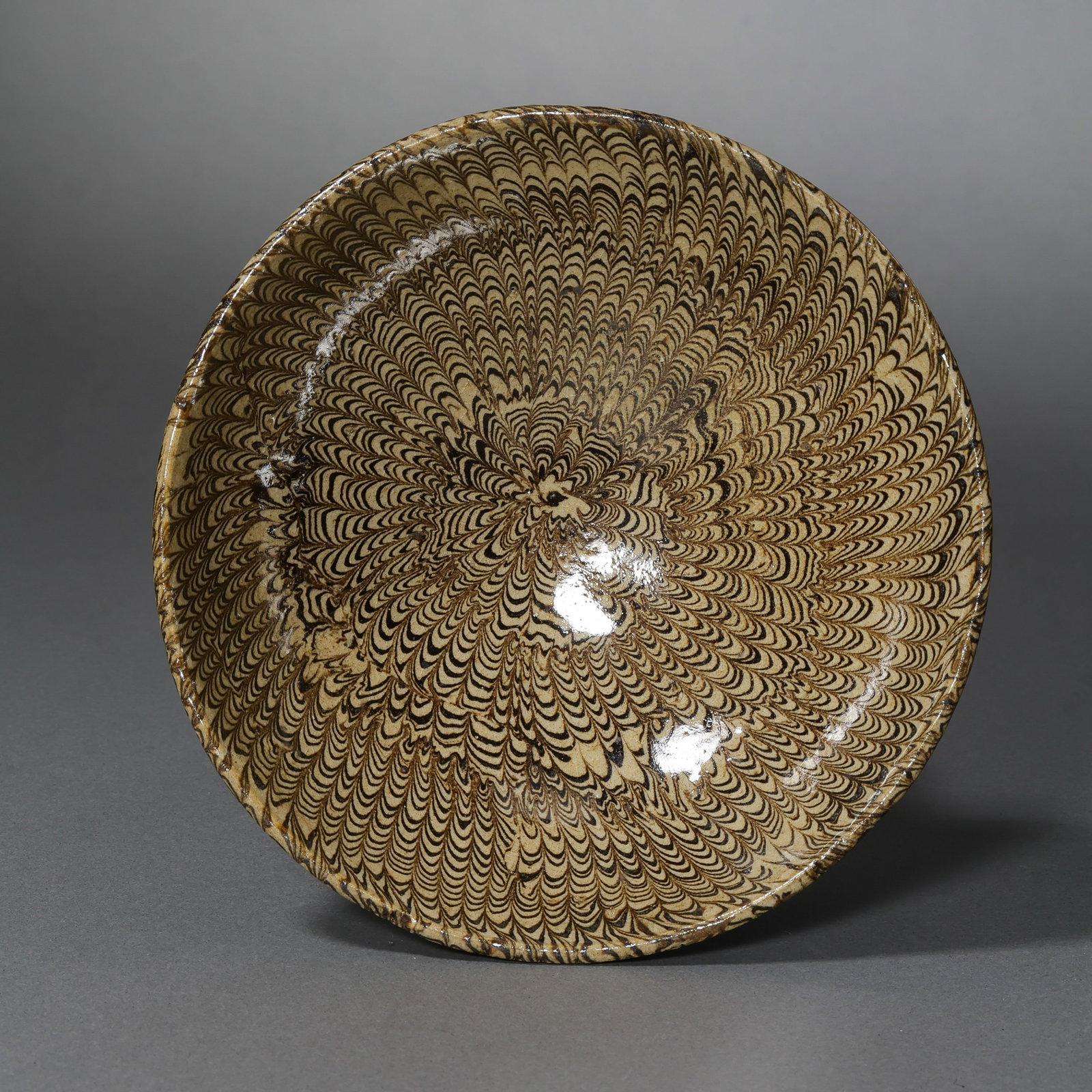 Black and white marbled glazed cup from Gongxian kiln in the Tang Dynasty, China: H. 4.2 cm. Diam. 11.3 cm.