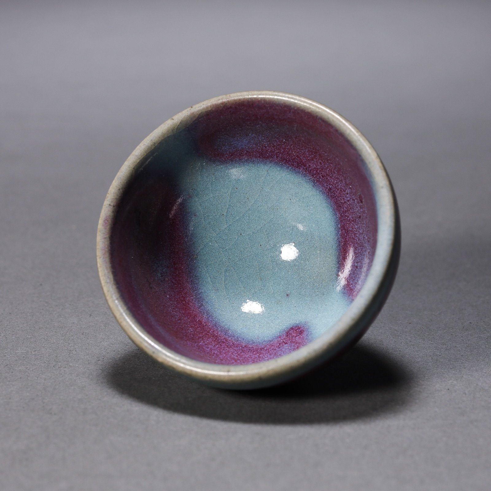 Small Jun ware cup with sky-blue glaze and red trim from the Northern Song Dynasty of China: H. 3.6 cm. Diam. 5.9 cm.