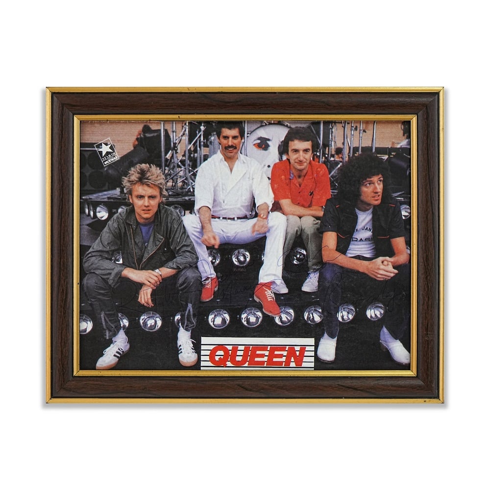 QUEEN FULLY SIGNED 1984 TOUR PROMOTIONAL PHOTOGRAPH: 10 5/8 x 8 1/8 in (27 x 20.5 cm) Framed Dimensions: 12 3/4 x 10 1/4 in (32.5 x 26 cm) This promotional photograph depicts Queen during their celebrated 1984 world tour, a period that followed the
