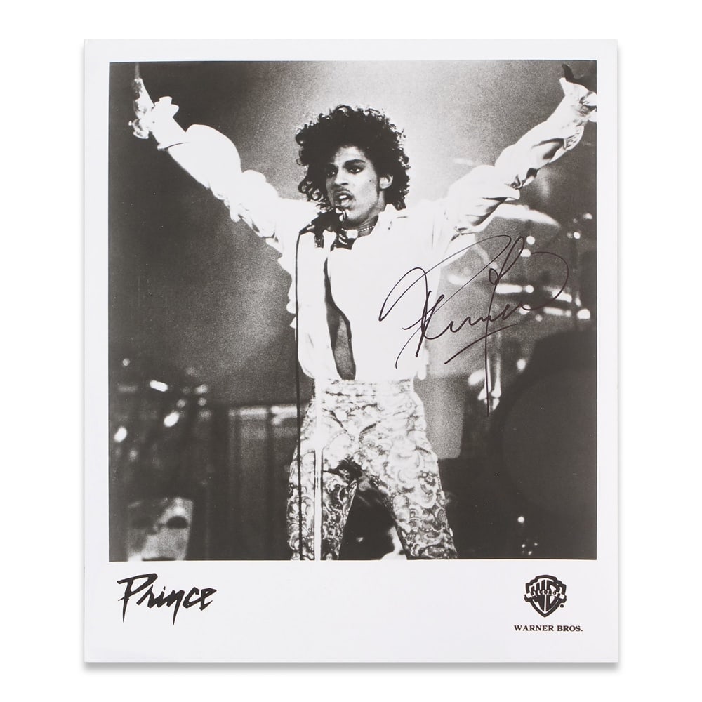 PRINCE SIGNED WARNER BROS. PROMOTIONAL PHOTOGRAPH: 12 1/4 x 12 1/4 in Provenance and Authentication: This collectible has undergone a rigorous forensic evaluation. The signatures were carefully analyzed across multiple criteria, including ink depositi