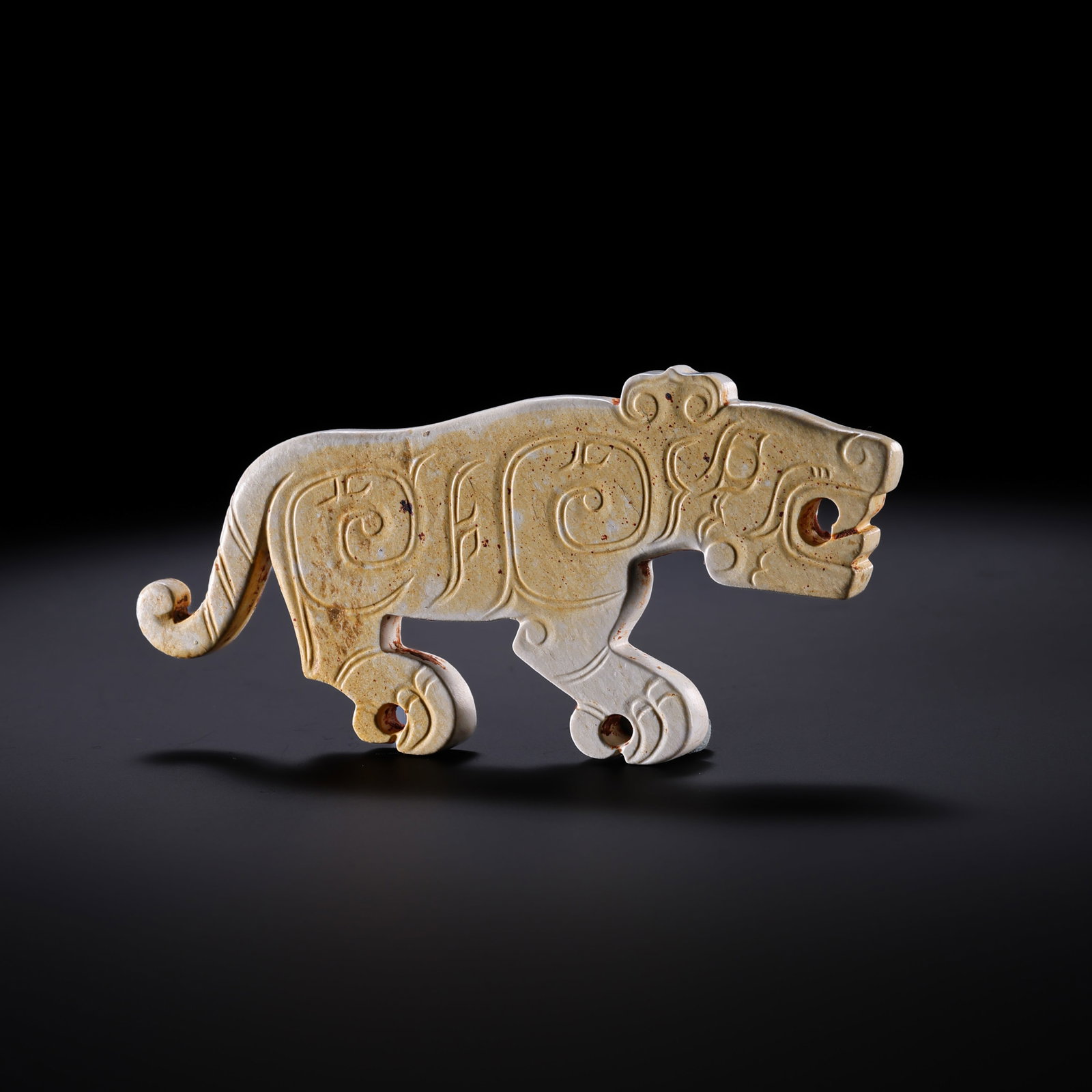 Jade auspicious beasts from the Western Zhou Dynasty in China: H. 3.5 cm. W. 8 cm. Weight. 24 gram.