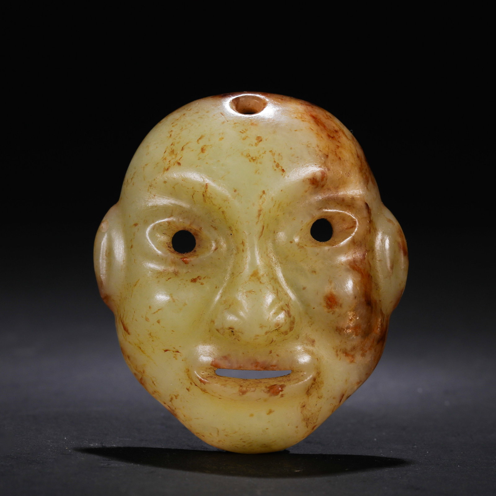 Jade face of Hongshan Culture during the Hongshan period in China: H. 5 cm. W. 4.5 cm. Weight. 23 gram.