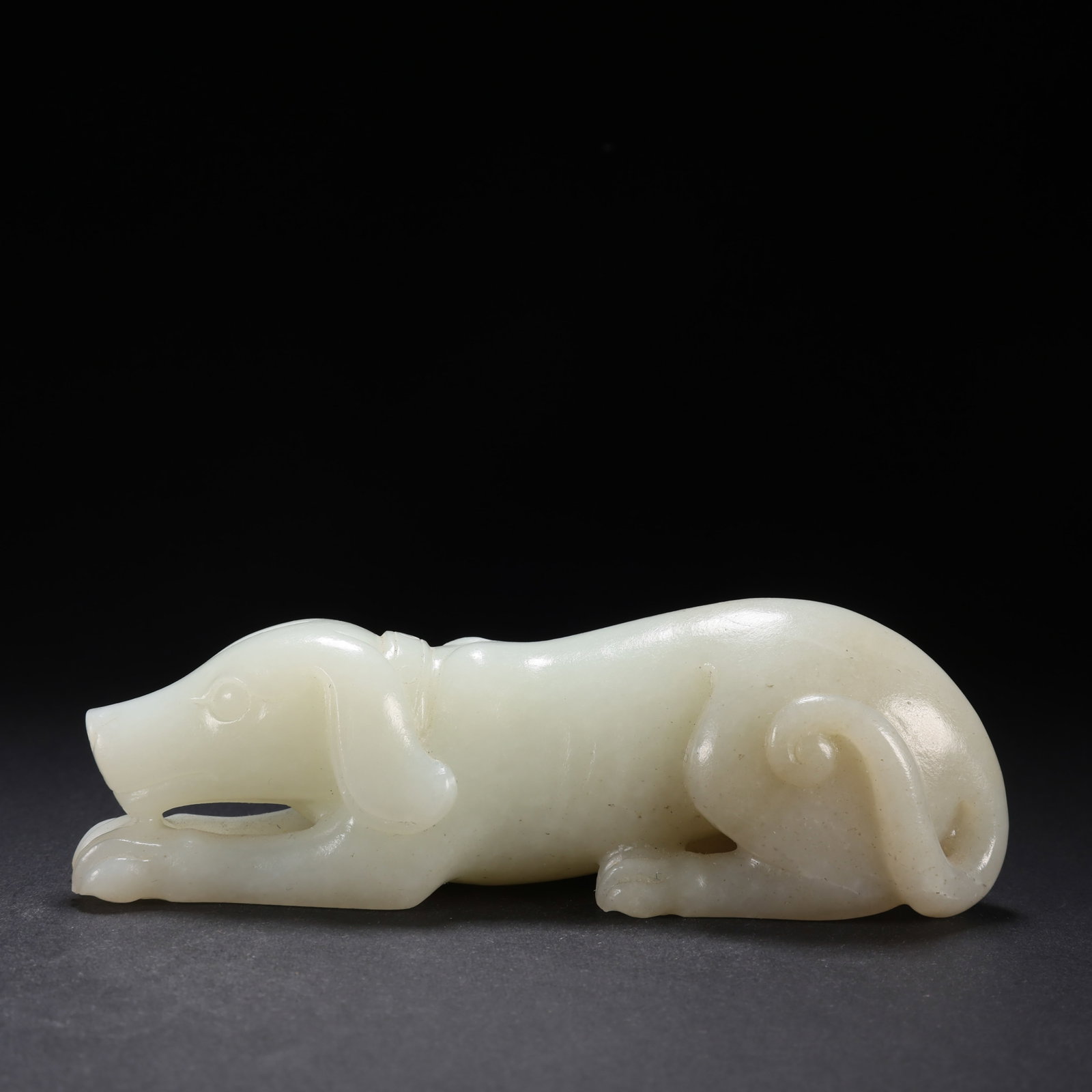 Chinese Qing Dynasty Hetian Jade Dog: L. 12 cm. W. 3.1 cm. H. 3.4 cm. Weight. 220 gram.