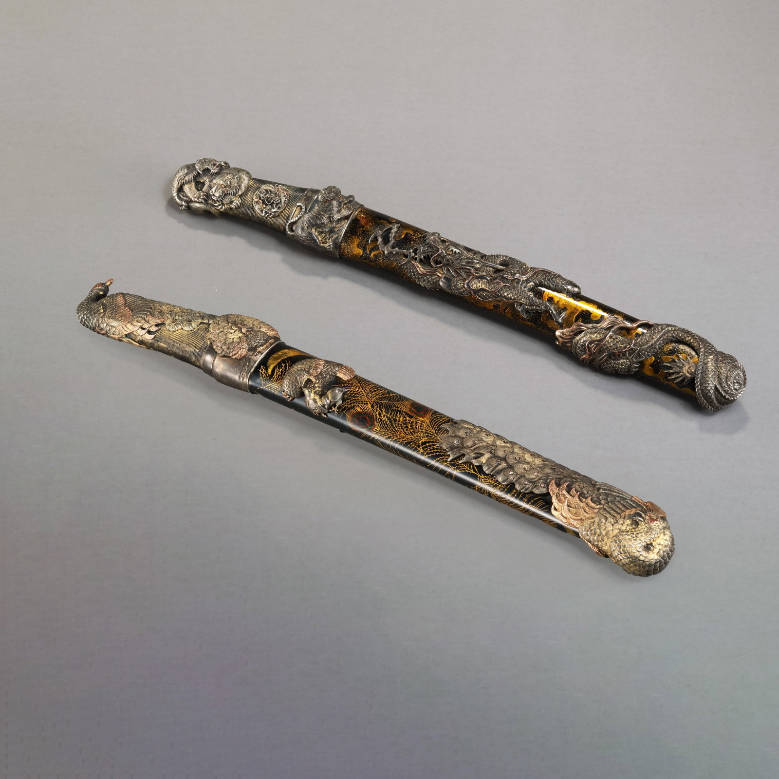 A pair of Japanese dragon and phoenix silver swords: L. 42 cm.