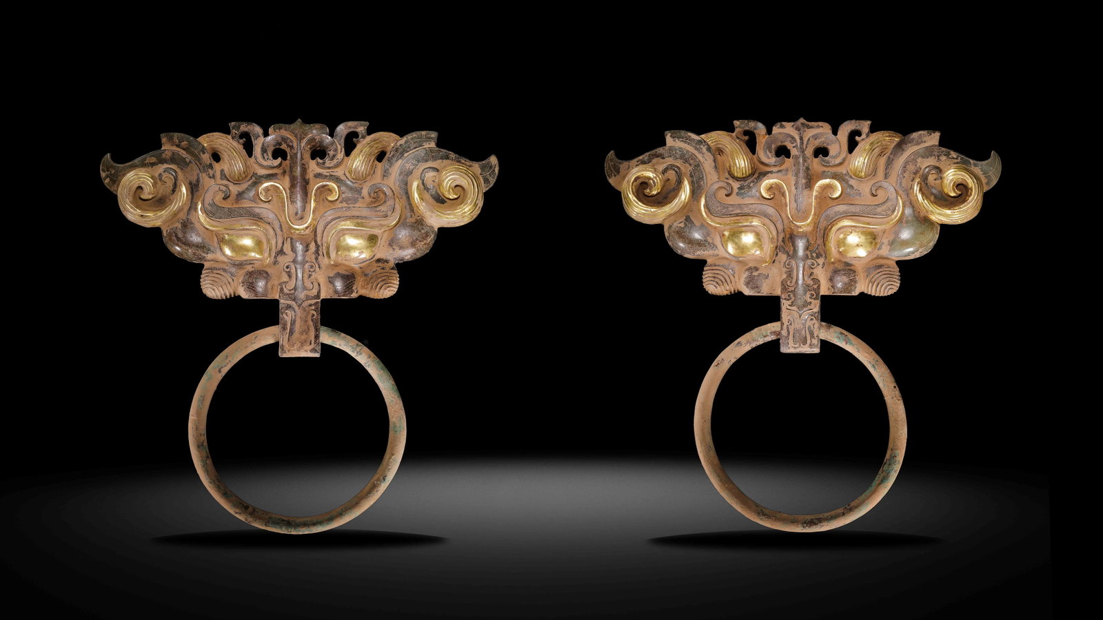 A pair of Chinese Han Dynasty gold-inlaid door knockers: H. 33.5 cm. L. 32.8 cm. Weight. 2342 gram. H. 33.5 cm. L.32.8 cm. Weight. 2313 gram.