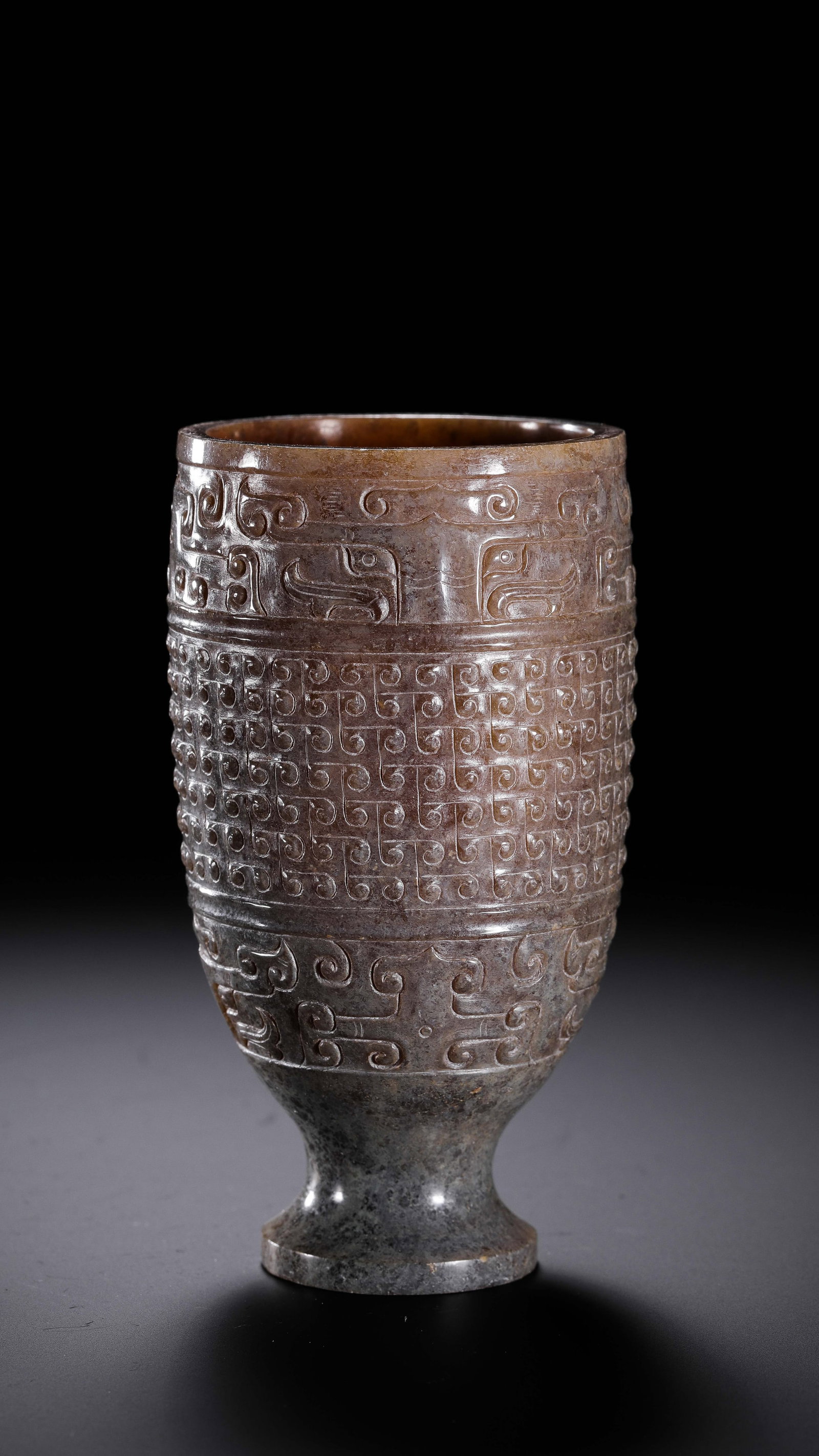 Jade cup with cloud pattern from the Warring States period of China: H. 9.8 cm. W. 5.5 cm. Weight. 175 gram.