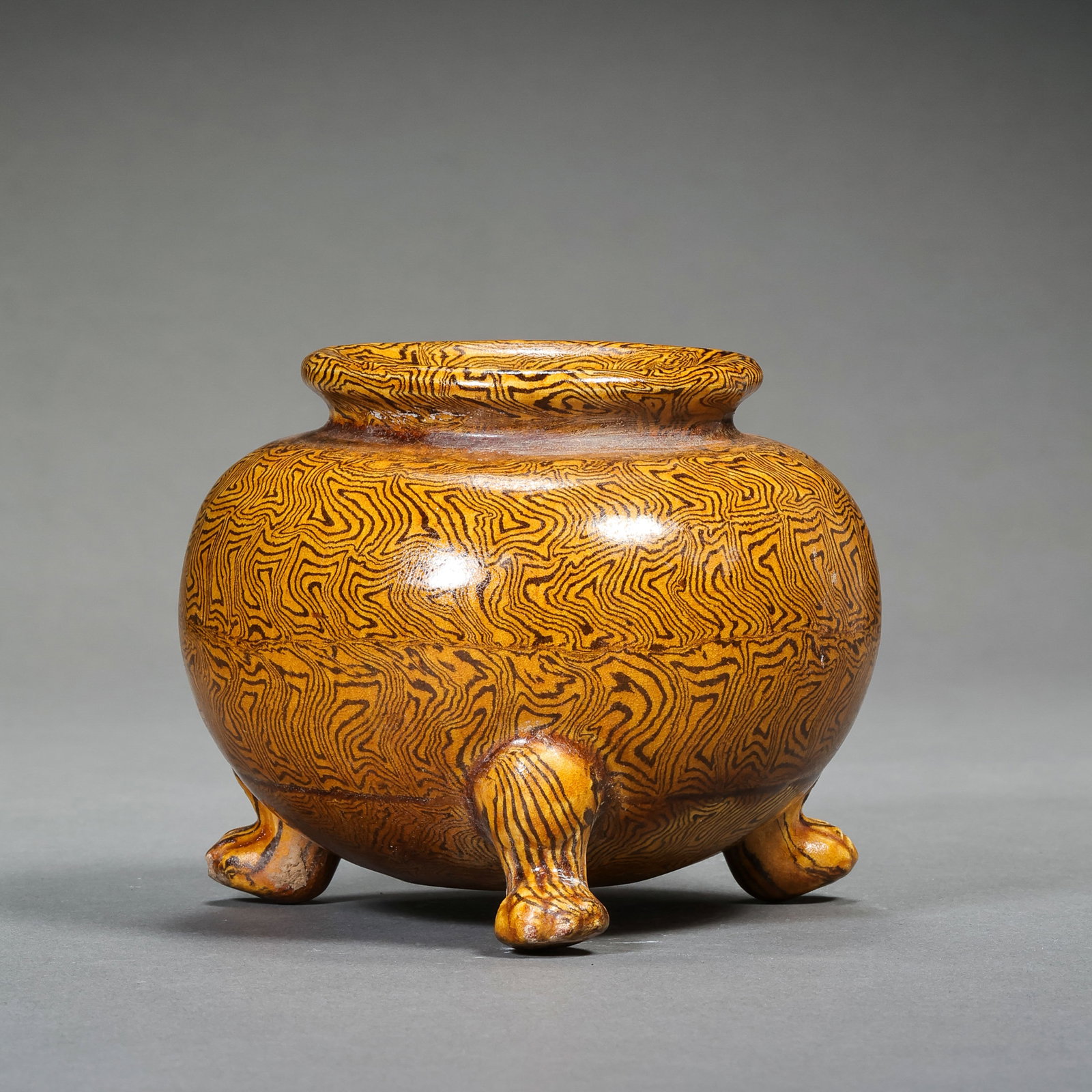 A three-legged yellow-glazed clay censer from the Tang Dynasty in China: H. 8 cm. W. 10 cm.