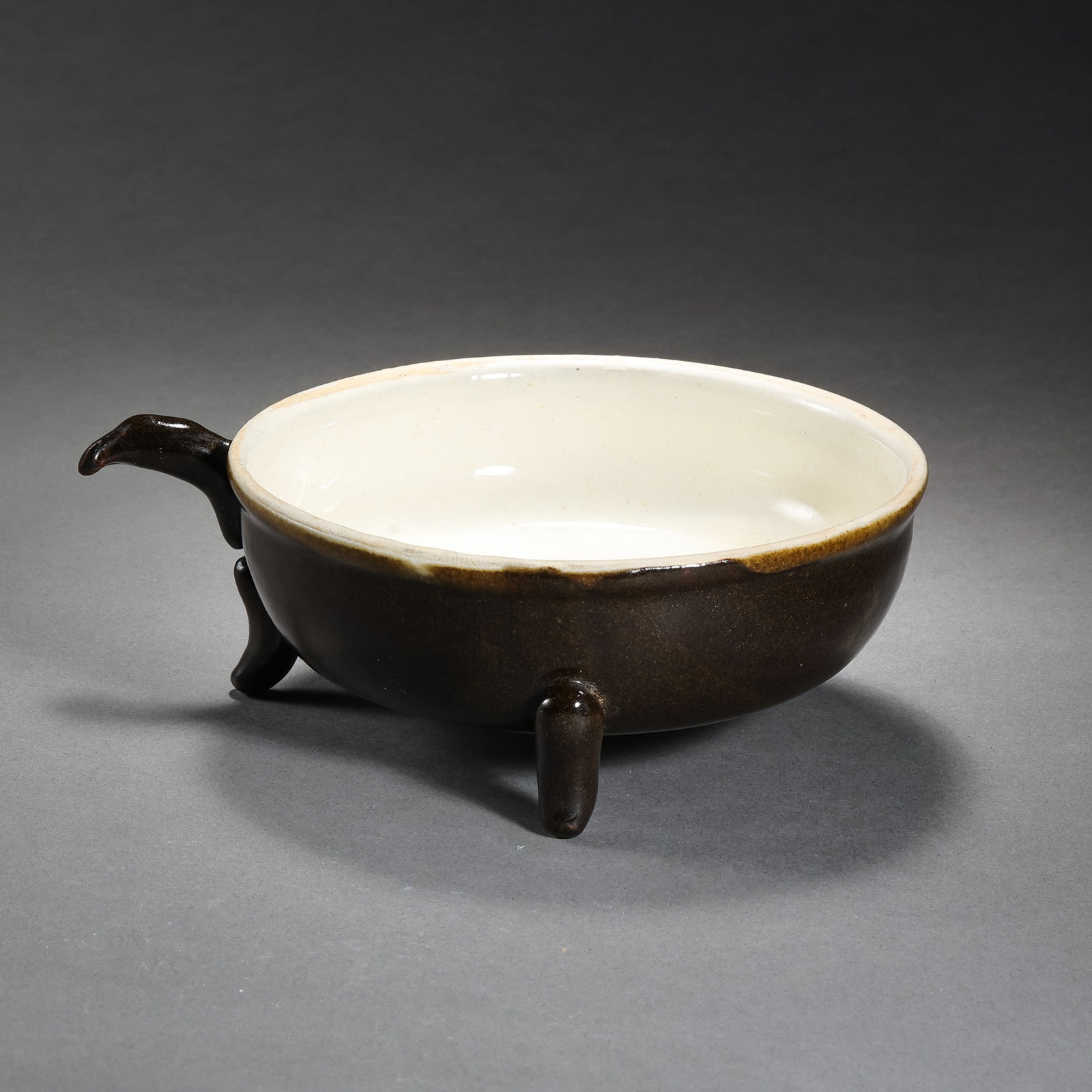 A three-legged tea cauldron from the Tang Dynasty in China: H. 5 cm. Diam. 15.5 cm.