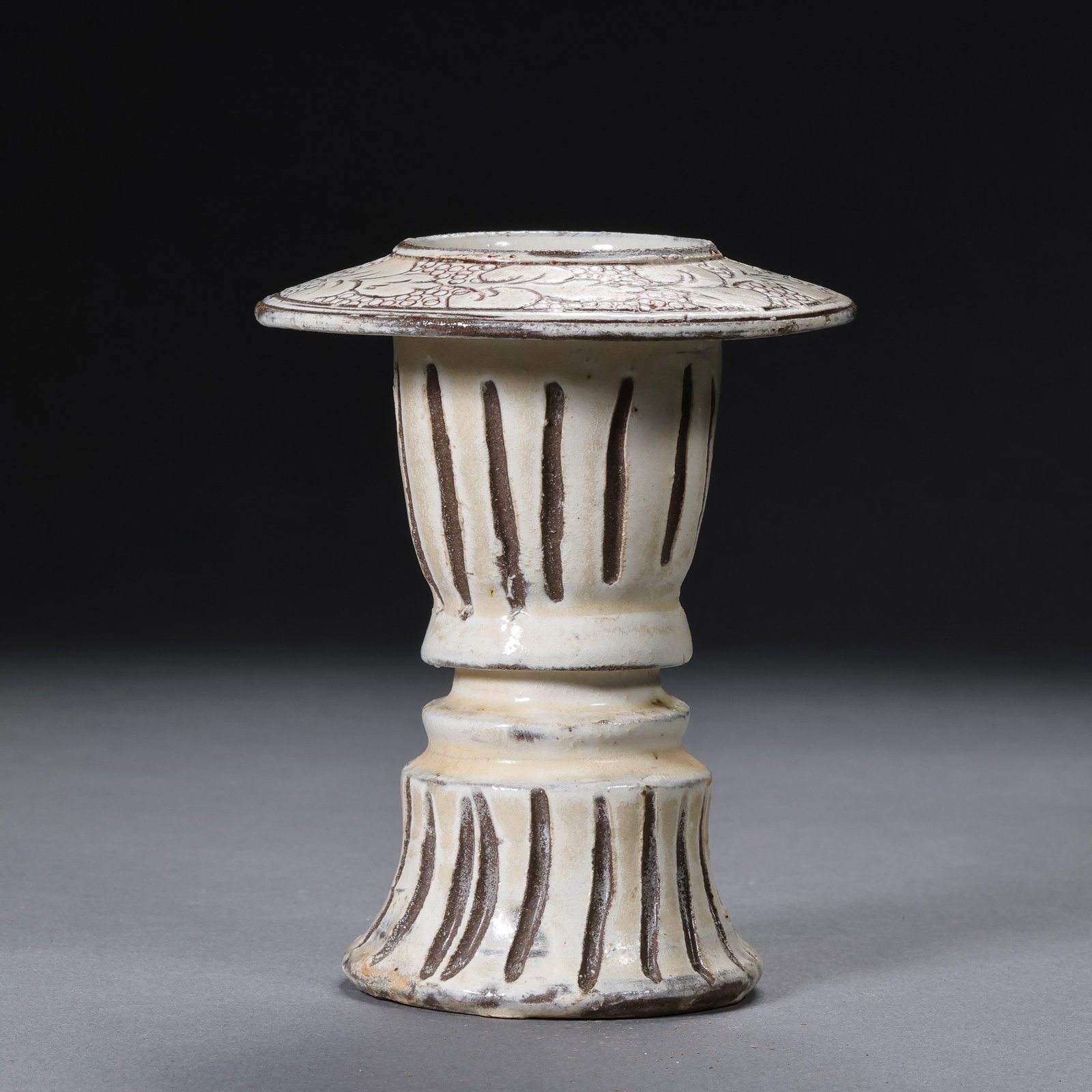 A white-glazed carved incense burner from the Cizhou kiln of the Northern Song Dynasty in China.: H. 10.3 cm. Diam. 8.5 cm.