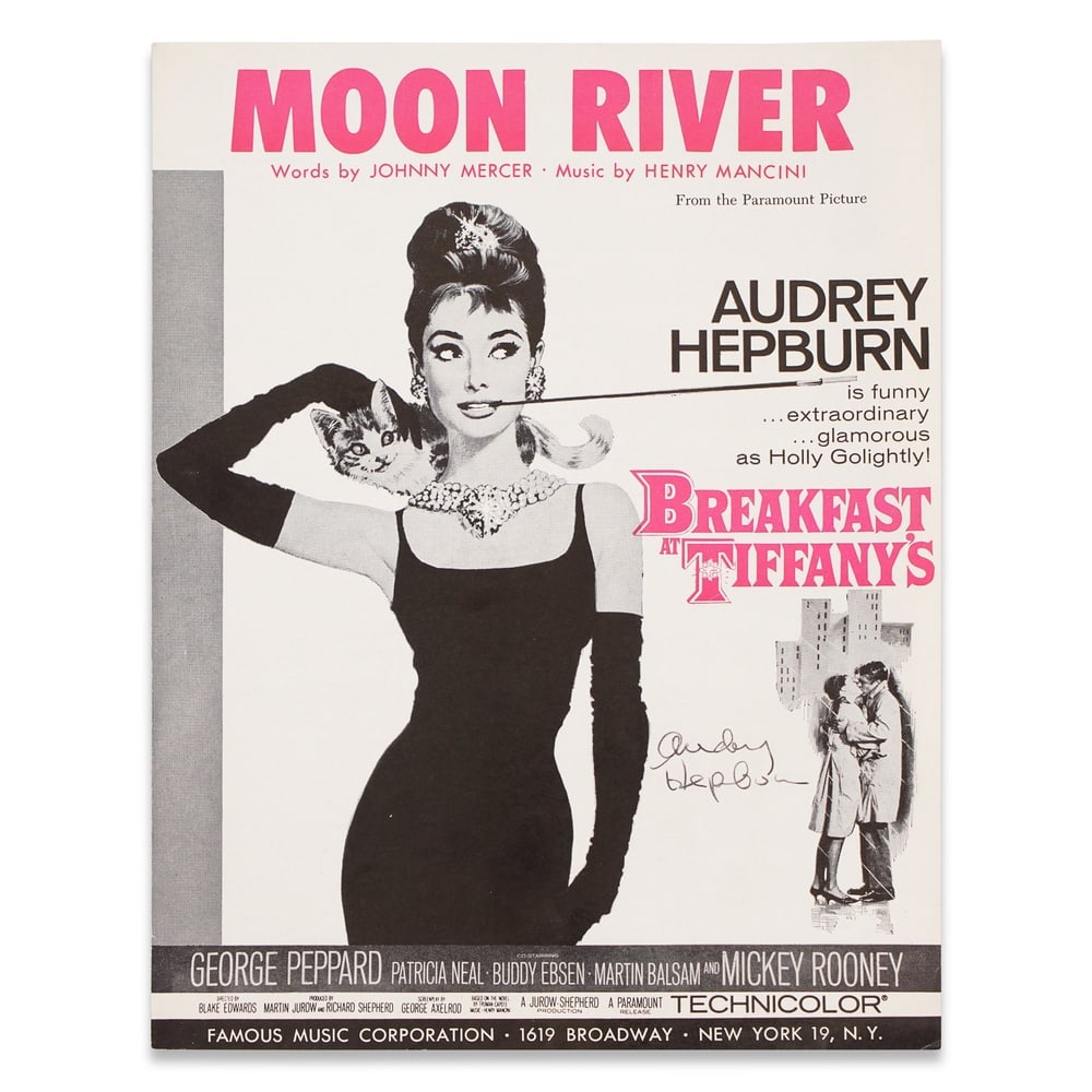 AUDREY HEPBURN SIGNED "MOON RIVER" SHEET MUSIC FROM "BREAKFAST AT TIFFANY'S": 11 7/8 x 9 1/8 in (30.2 x 23 cm) Provenance and Authentication: According to the Letter of Authenticity (LOA) and Certificate of Authenticity (COA) provided by the consignor, this collectible was