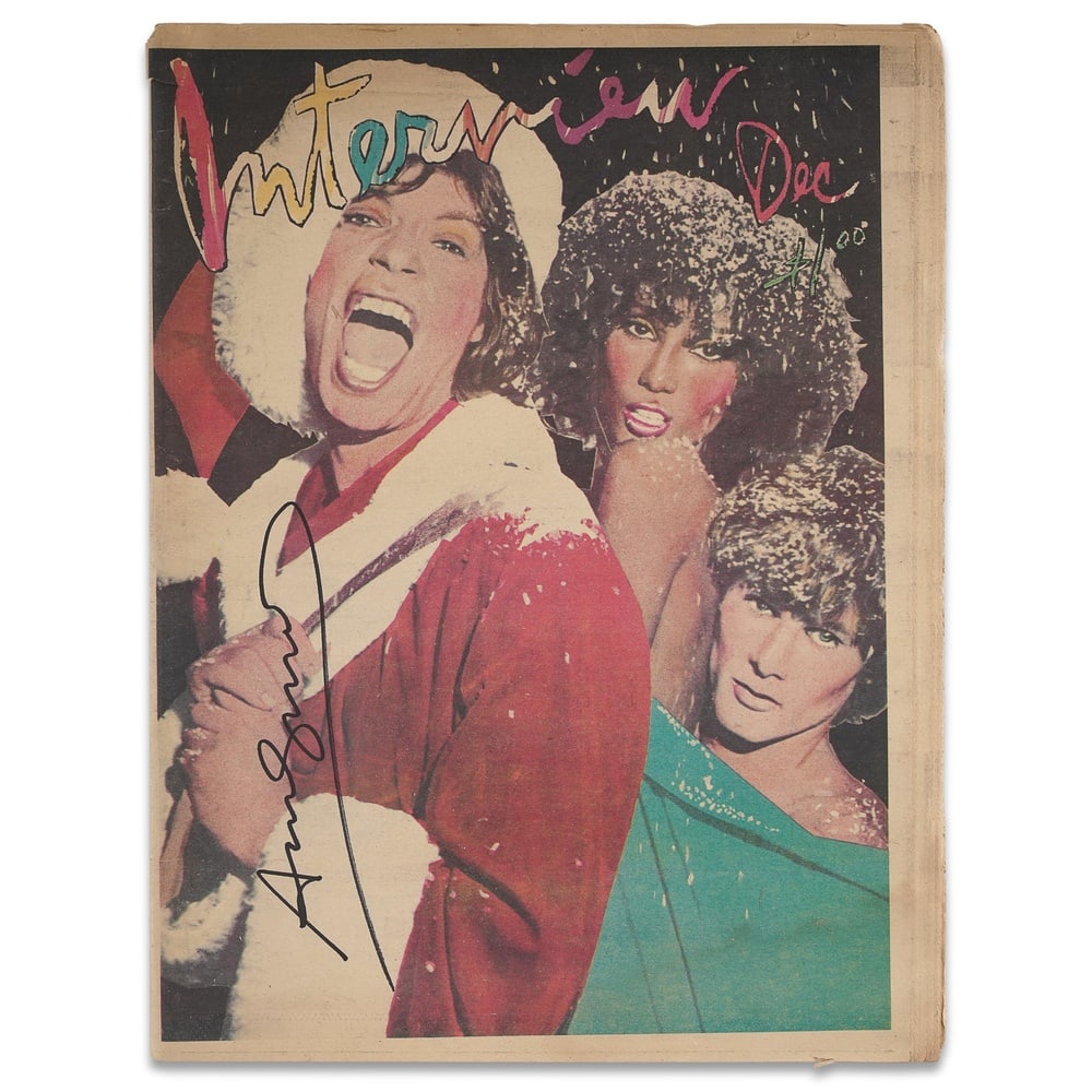 ANDY WARHOL SIGNED "INTERVIEW" MAGAZINE: 15 1/8 x 11 in (38.5 x 28 cm) Provenance and Authentication: According to the Letter of Authenticity (LOA) and Certificate of Authenticity (COA) provided by the consignor, this collectible was