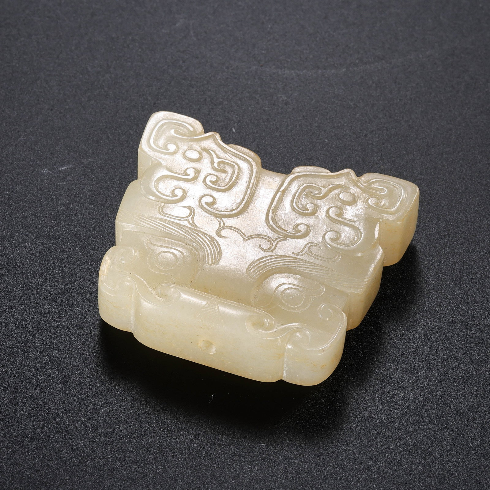 Chinese Han Dynasty jade pendant with animal mask design: H. 3.3 cm. W. 4 cm. Weight. 38 gram.
