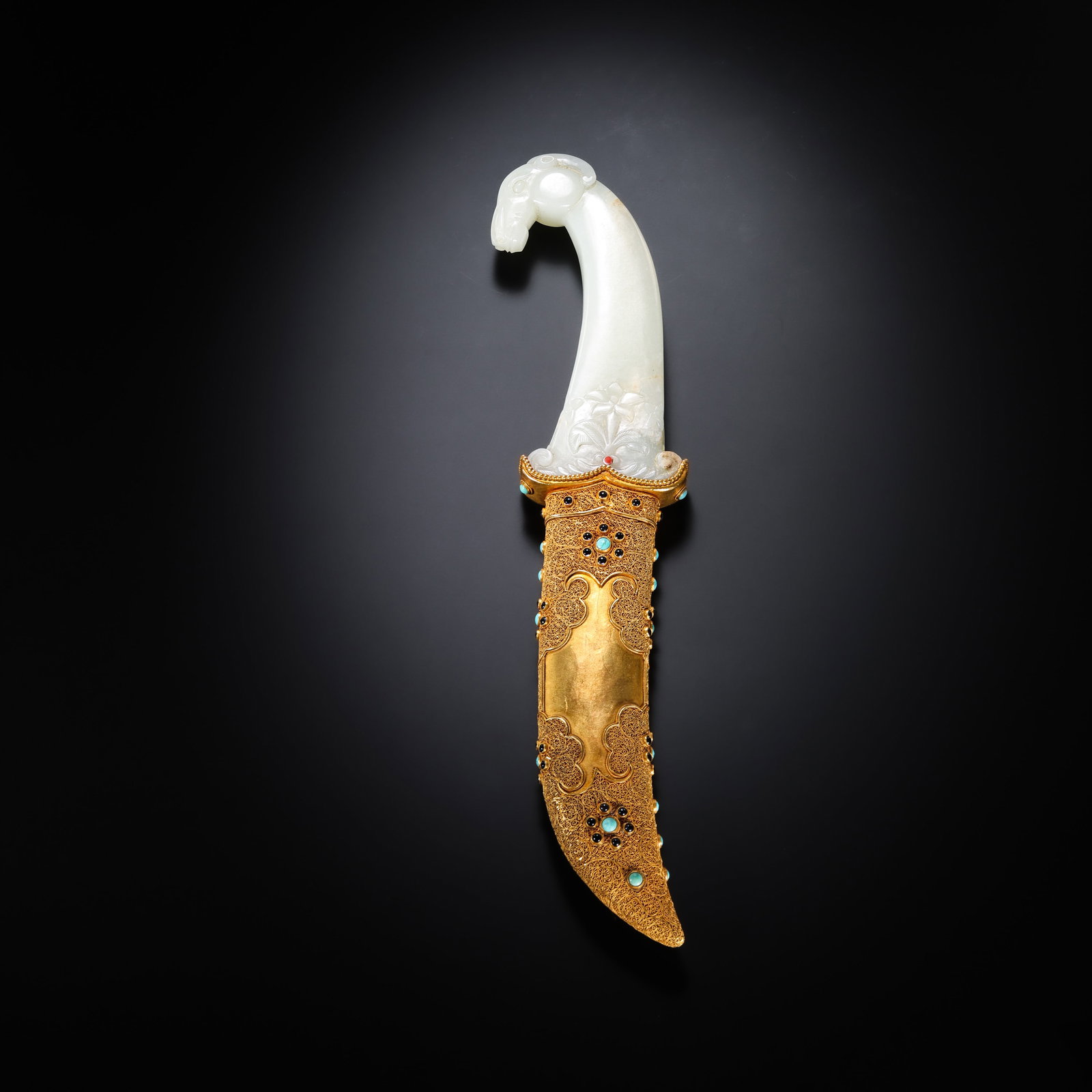 A gilded and gem-inlaid Hetian jade knife from the Qing Dynasty in China. (1 of 9)