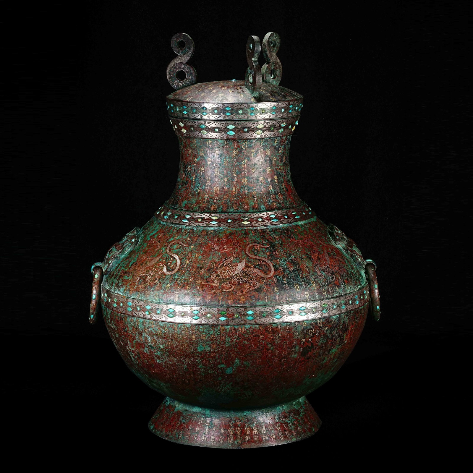 A round pot with double ring handles, inlaid with gold and silver and turquoise, from the Warring: /