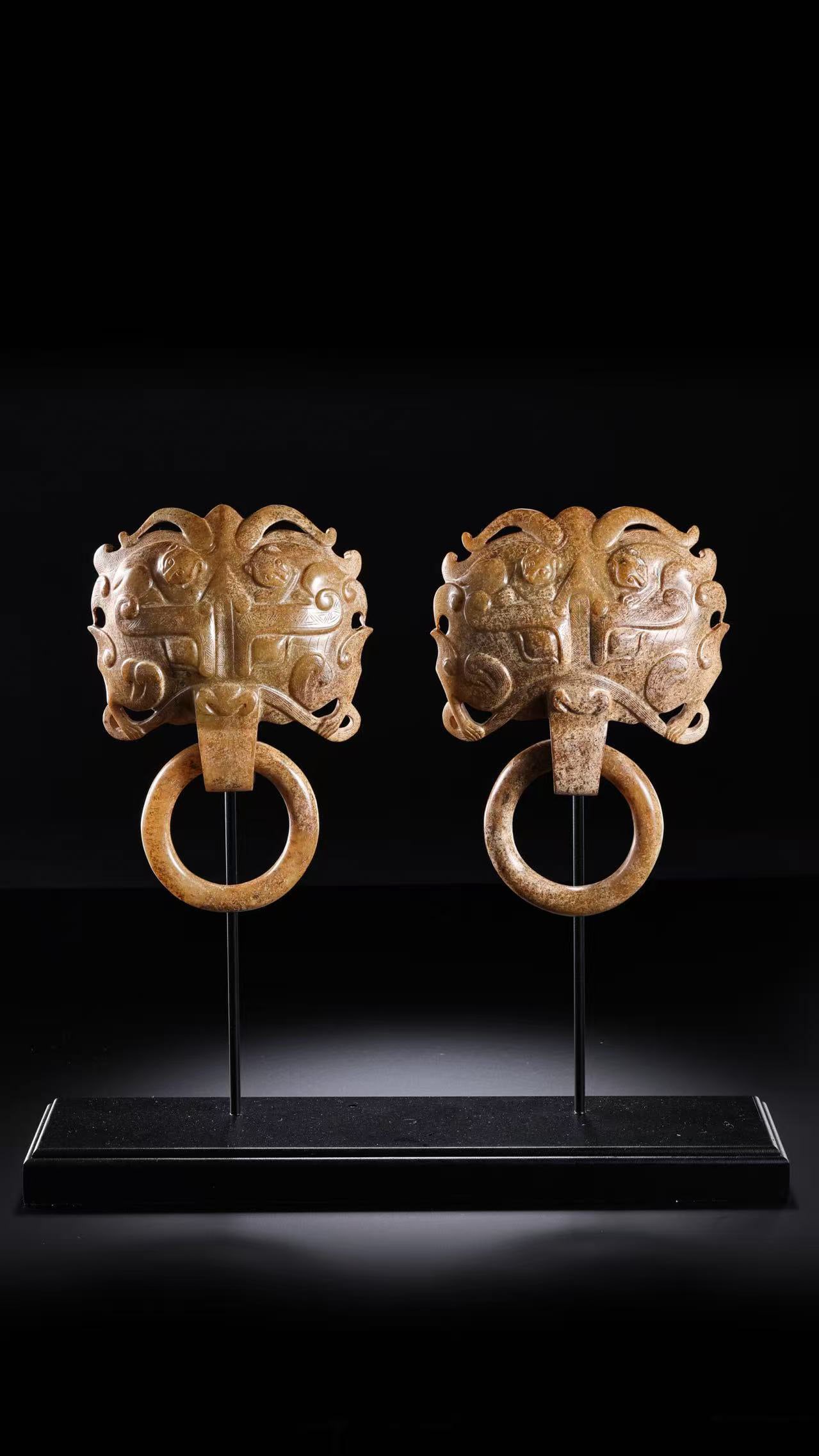 A pair of Chinese Han Dynasty jade door knockers with animal mask designs: H. 14.5 cm. W. 10.5 cm. Weight. 693 gram.