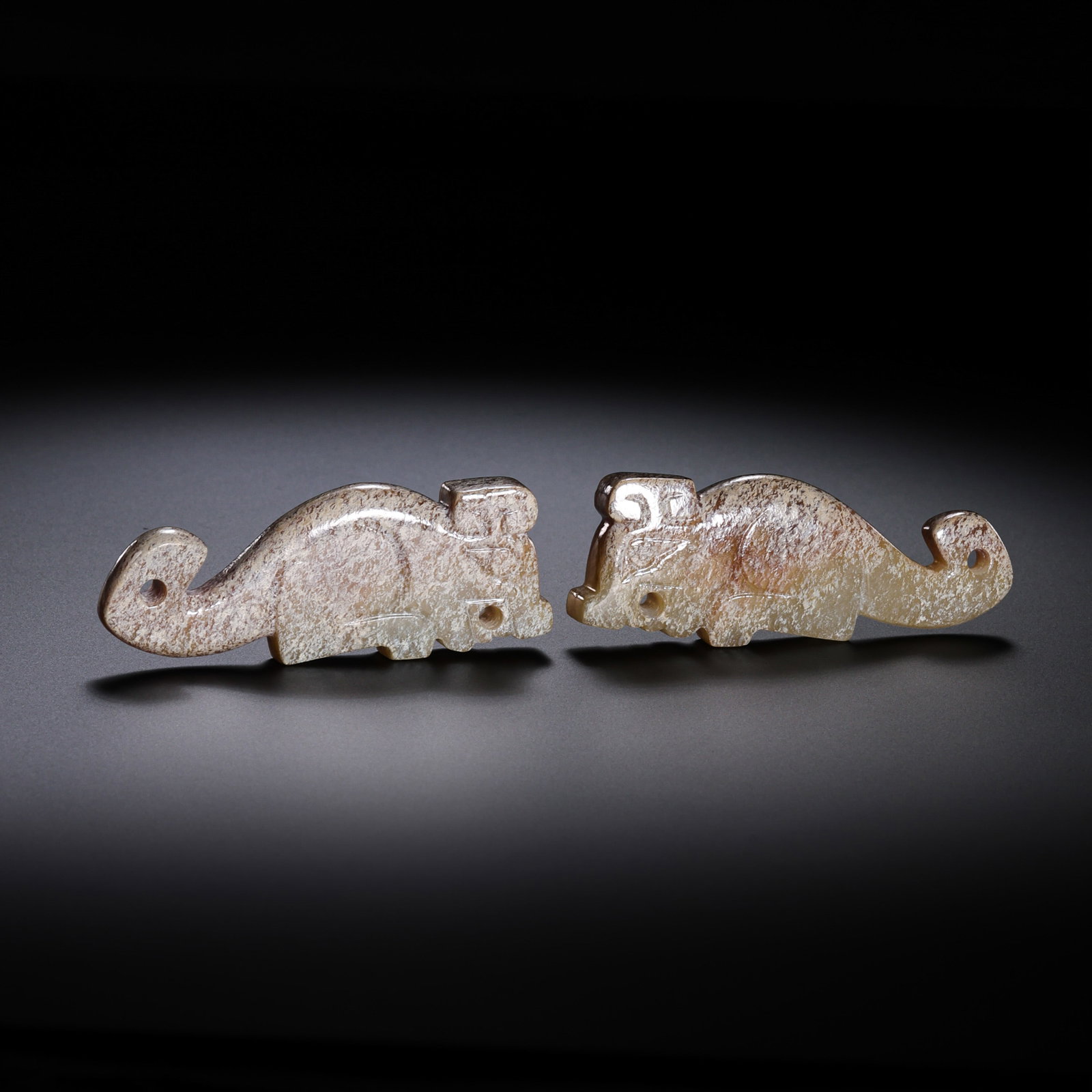 A pair of Chinese Han Dynasty jade artifacts: H. 2.1 cm. W. 5.2 cm. Weight. 25.2 gram.