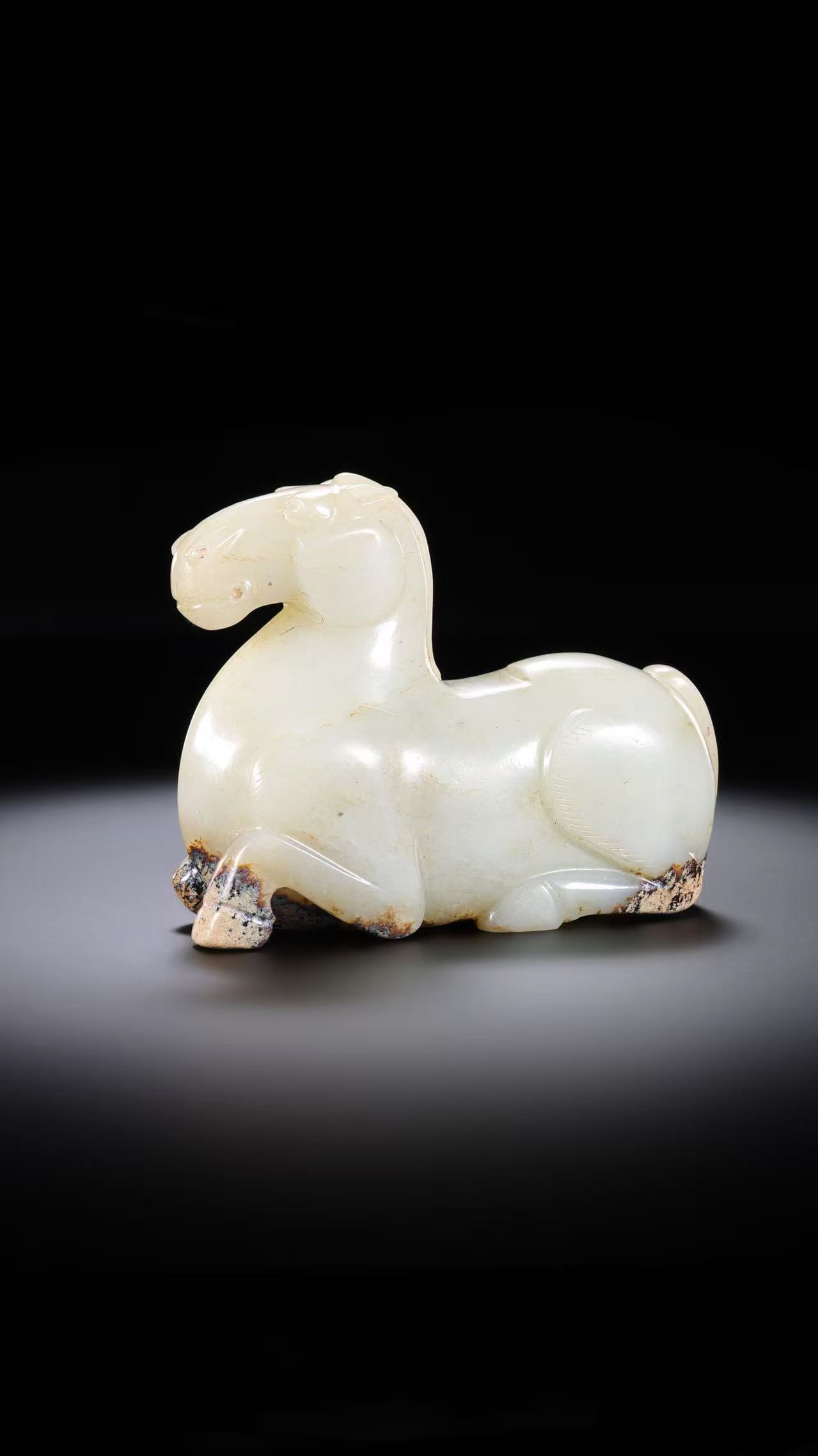 Chinese Han Dynasty White Jade Reclining Horse: H. 7.4 cm. W. 9.35 cm. Weight. 349 gram.