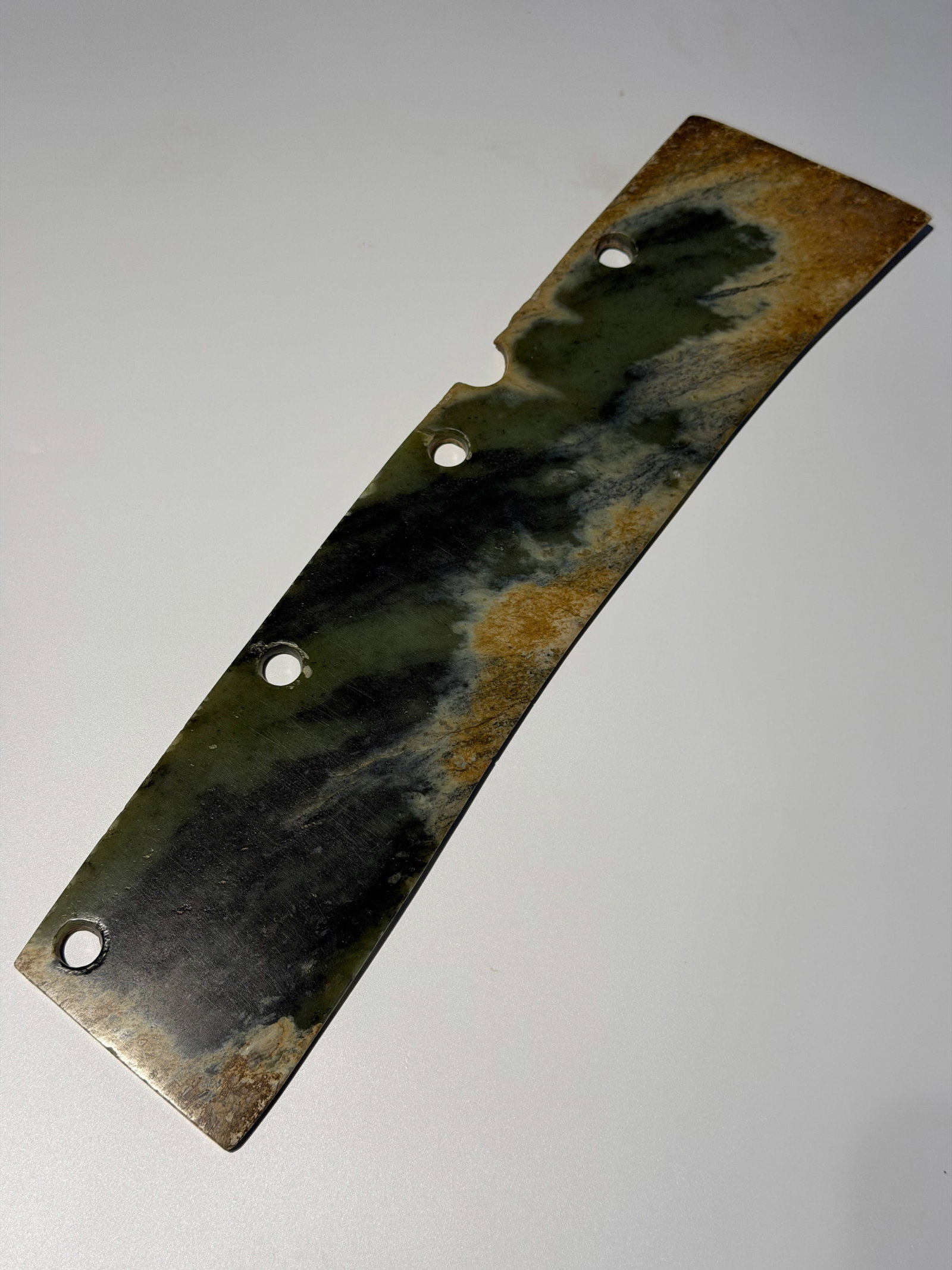 Jade five-hole knife from the Qijia Culture of the Neolithic period in China: L. 36.5 cm. W. 8.5 cm.