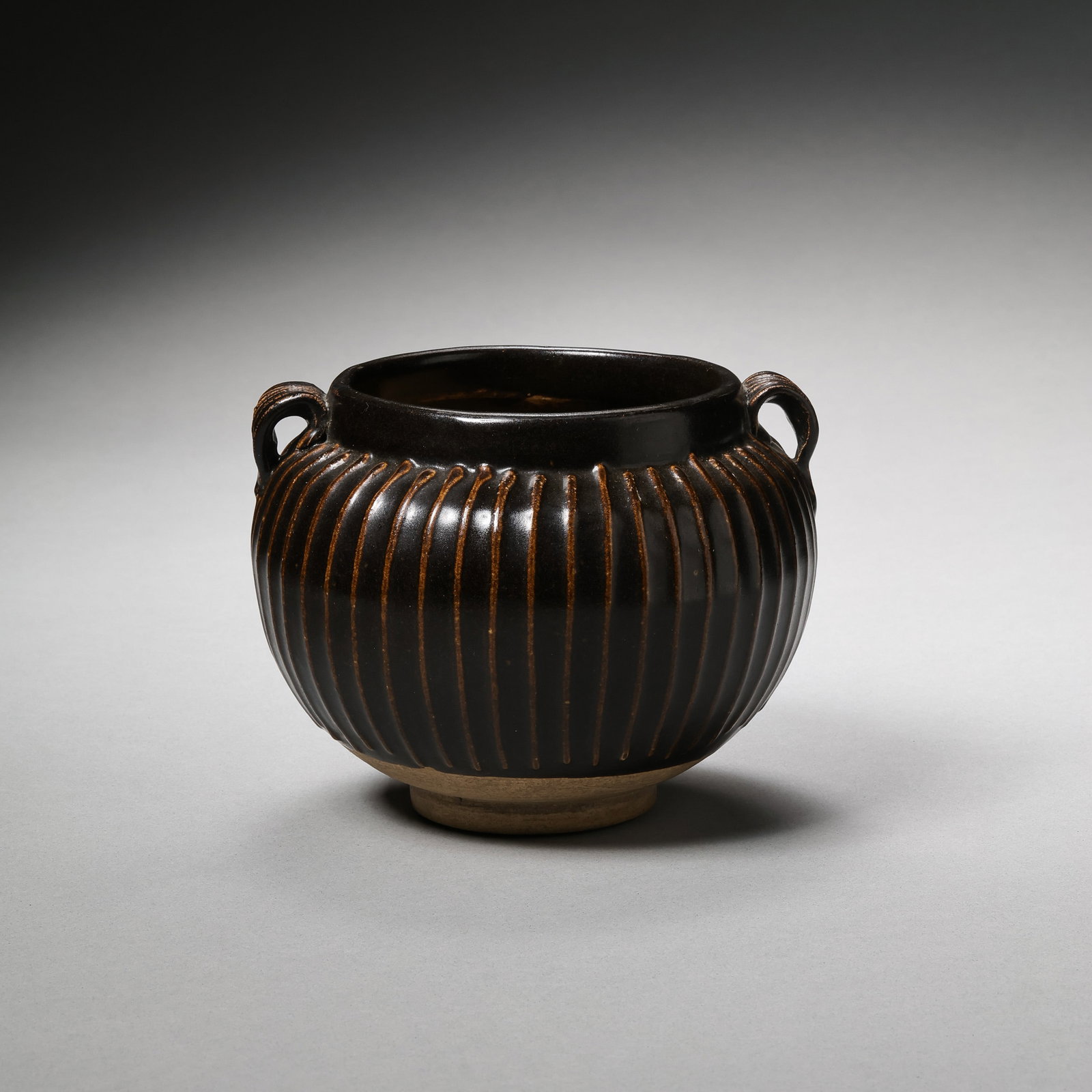 Northern Song Dynasty Cizhou Kiln Black Glazed Double-Handled Line Jar: H. 10.2 cm. W. 13.3 cm.