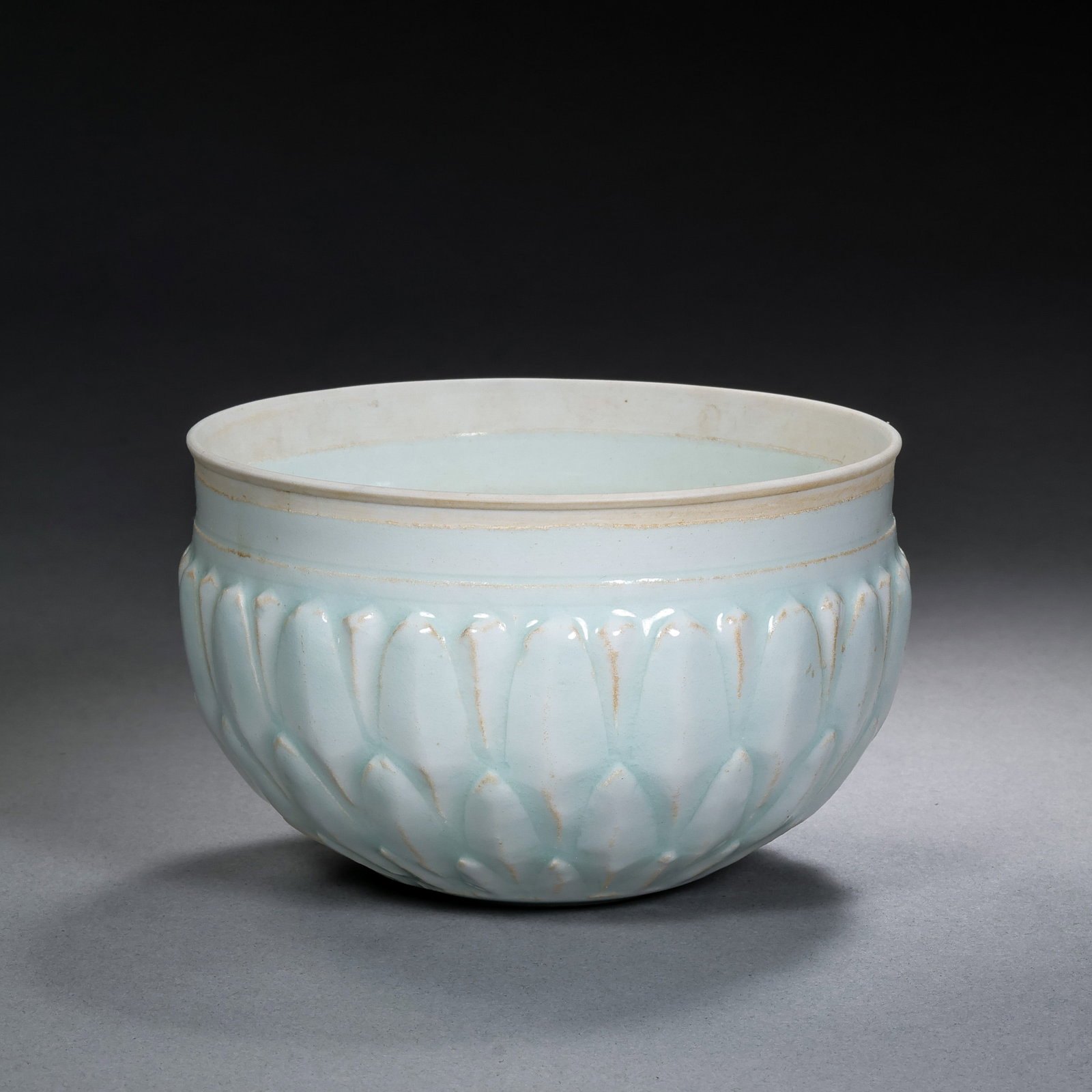 A celadon-glazed lotus-petal-patterned bowl from the Hutian kiln of the Southern Song Dynasty,: H. 6 cm. Diam. 9.4 cm.