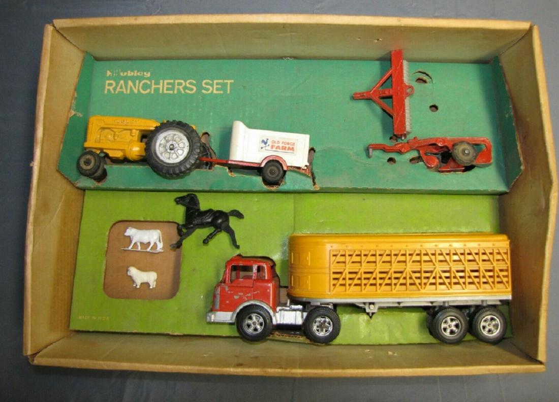 Hubley Vehicle Rancher's set #1048 +Box: Hubley Vehicle Rancher's set #1048 +Box Includes yellow Tractor, while animal trailer, 2 row plow, disc/roller, red Tractor and Yellow stock trailer. sheep, cow.