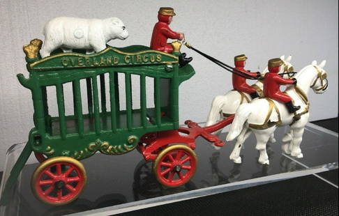 CAST IRON VEHICLE OVERLAND CIRCUS: This is a 1950s version of an Overland Circus Wagon in beautiful condition complete with original driver, polar bear and two riders. Rear gate folds down. Complete set in fine condition Made by