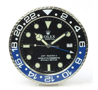 Rolex Style GMT Master II Batman Dealer Wall Clock: GMT Master II Dealers Wall Clock after Rolex Dealer's style wall clock inspired by the "BATMAN" wristwatch watch series. Quality replica having sweeping quartz movement powered by single AA battery.