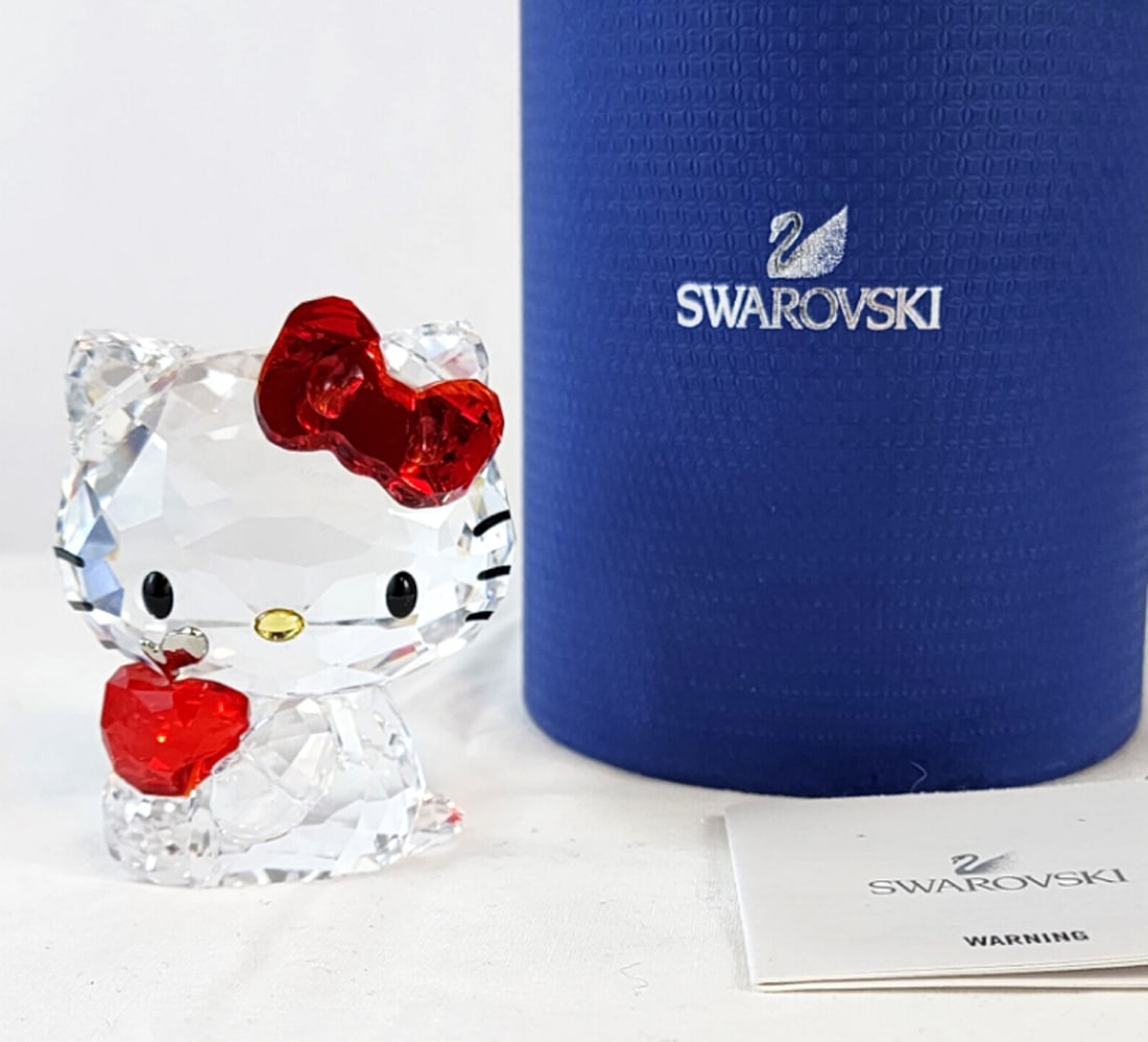 Swarovski Hello Kitty With Red Apple 1096878 Sanrio W Original Box: Swarovski Hello Kitty With Red Apple 1096878 Sanrio W Original Box. Measures approx 3-3/4” Tall x 2” Wide x 1-3/4” Deep