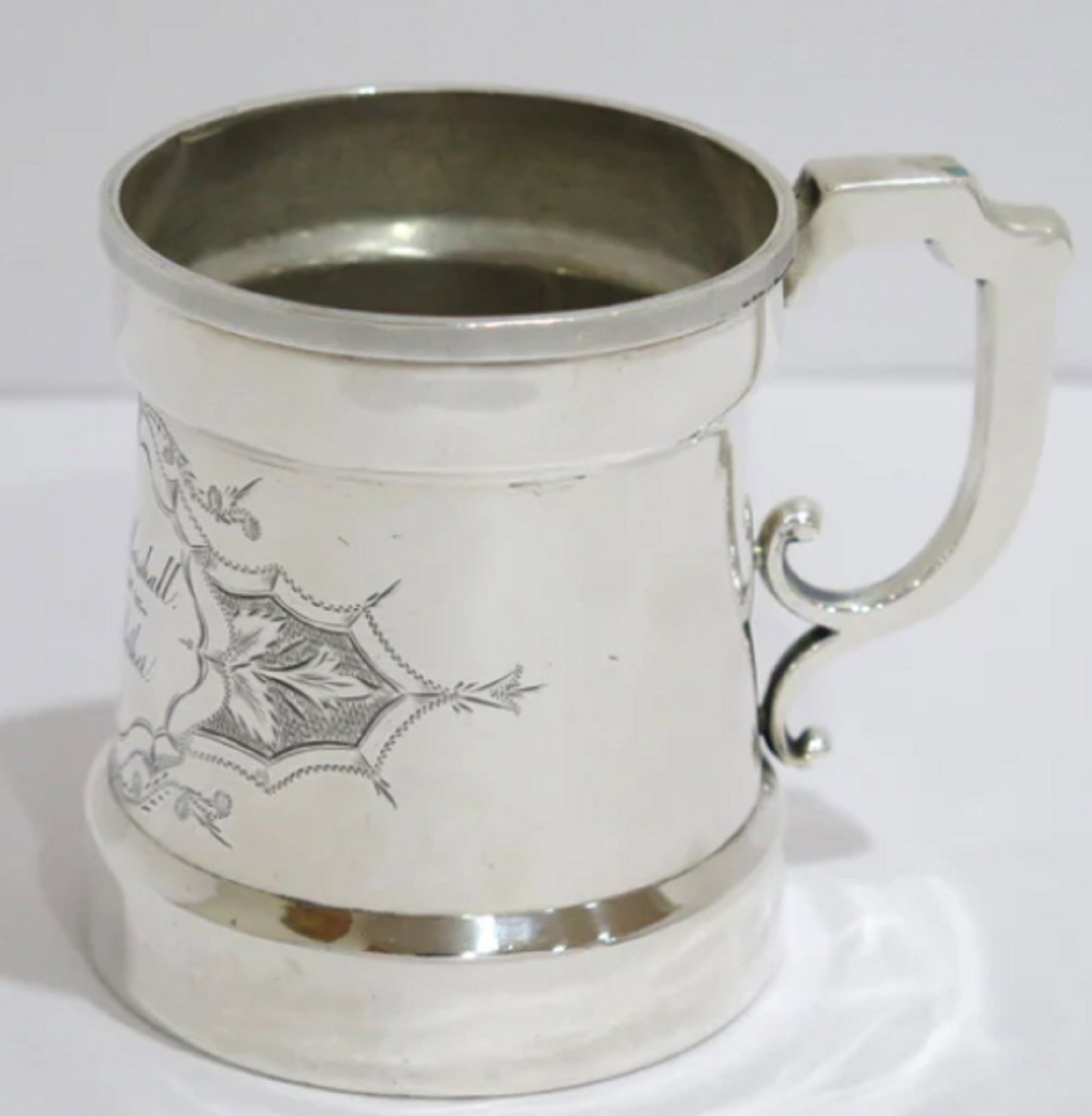 COIN SILVER ANTIQUE FLORAL SCROLL BABY CUP: COIN SILVER ANTIQUE FLORAL SCROLL BABY CUP The cup has some small dents on the bottom. Please see the last image. Measures approx Height: 3.5 inWidth: 4.25 inDiameter: 3 1/8 inWeight: 4.9 toz