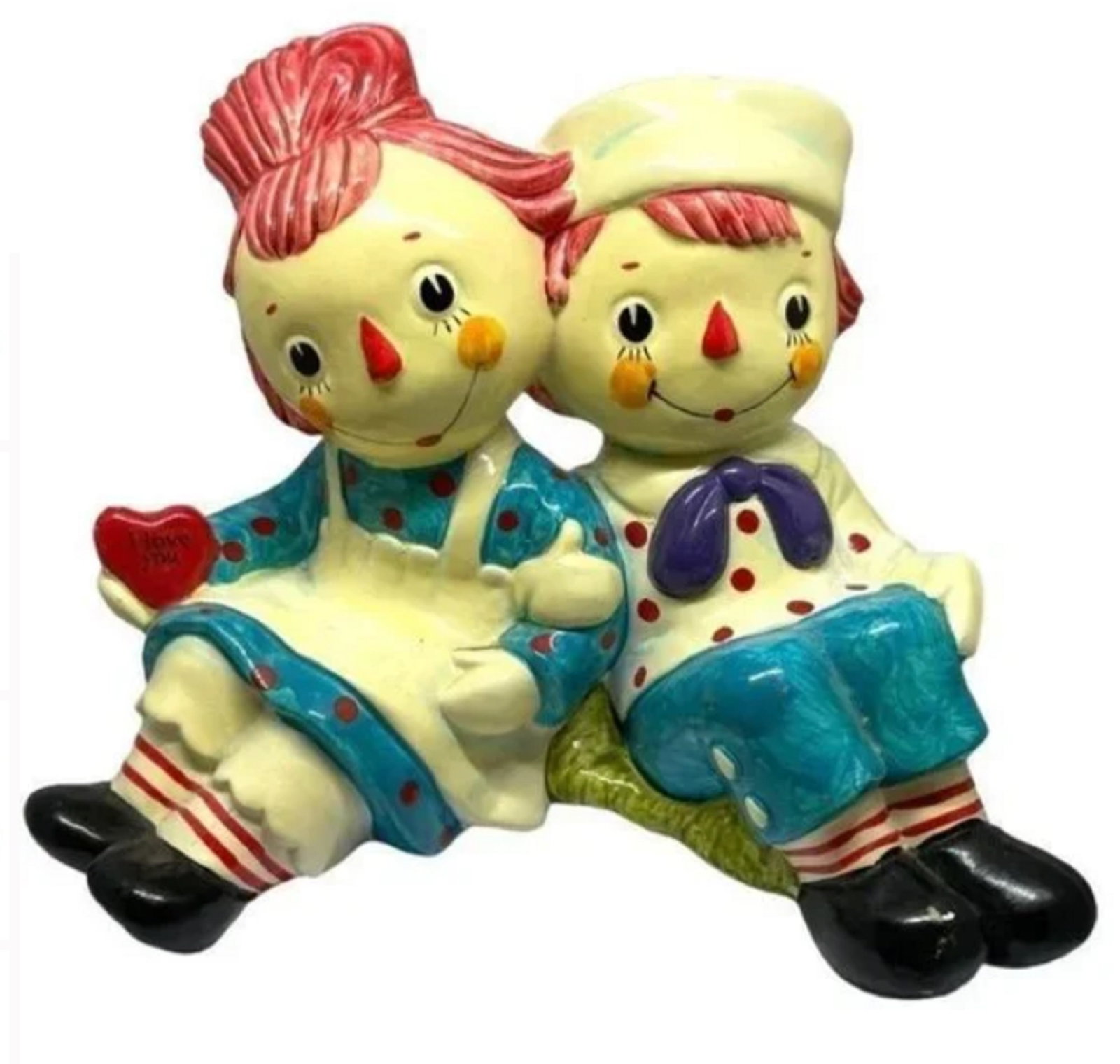 Raggedy Ann & Andy Coin Bank Figurine The Bobbs-Merrill Co.: Raggedy Ann & Andy Coin Bank Figurine The Bobbs-Merrill Co. The Bobbs-Merrill Co. Raggedy Ann & Andy Coin Bank FigurineFeatures: Ann holds "I love you" red heartColor: Multi-coloredBrand: Bobbs-Merril