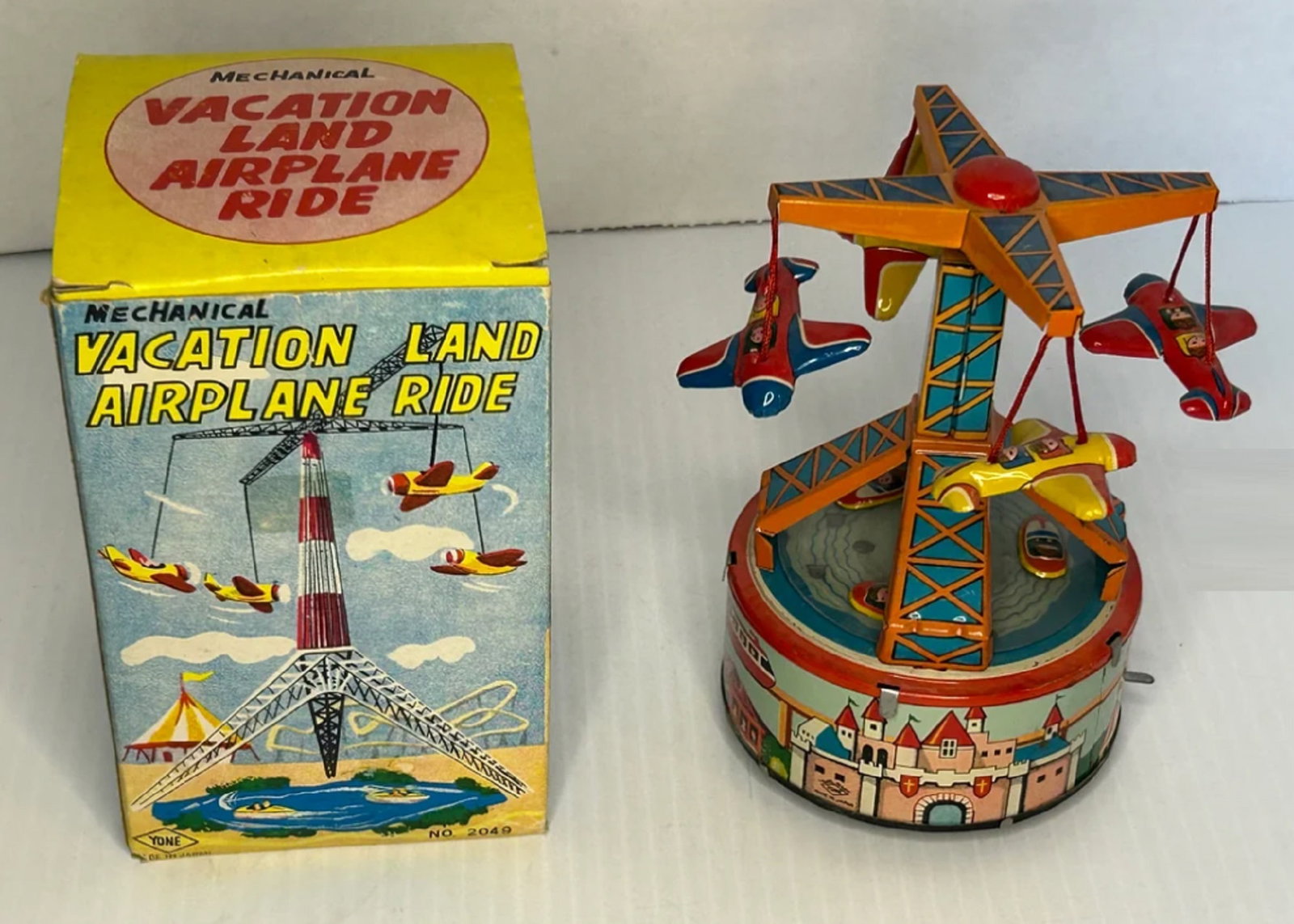 YonezawaTin Litho Toy Mechanical Vacation Land Airplane Ride with Original Box 1960's: YonezawaTin Litho Toy Mechanical Vacation Land Airplane Ride with Original Box The Mechanical Vacation Land Airplane Ride is a beautiful piece that showcases the craftsmanship of Japan's toy-making in